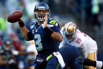 SEATTLE, WA - DECEMBER 14:  Quarterback Russell Wilson #3 of the Seattle Seahawks throws the ball during the first quarter of the game against the San Francisco 49ers at CenturyLink Field on December 14, 2014 in Seattle, Washington.  (Photo by Otto Greule