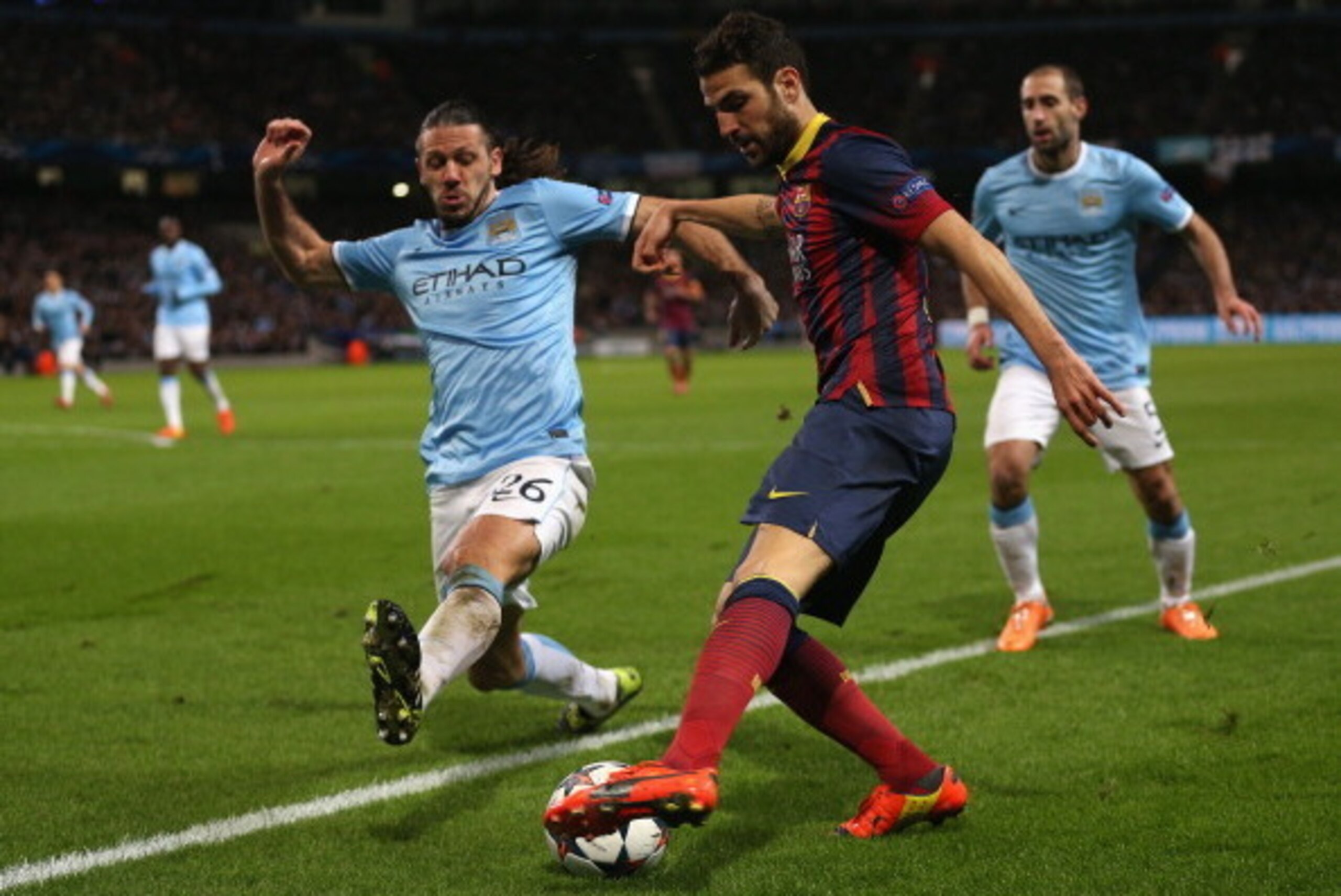 MANCHESTER, ENGLAND - FEBRUARY 18: Martin Demichelis of Manchester City competes with Cesc Fabregas of Barcelona during the UEFA Champions League Round of 16 first leg match between Manchester City and Barcelona at the Etihad Stadium on February 18, 2014 MANCHESTER, ENGLAND - FEBRUARY 18: Martin Demichelis of Manchester City competes with Cesc Fabregas of Barcelona during the UEFA Champions League Round of 16 first leg match between Manchester City and Barcelona at the Etihad Stadium on February 18, 2014
