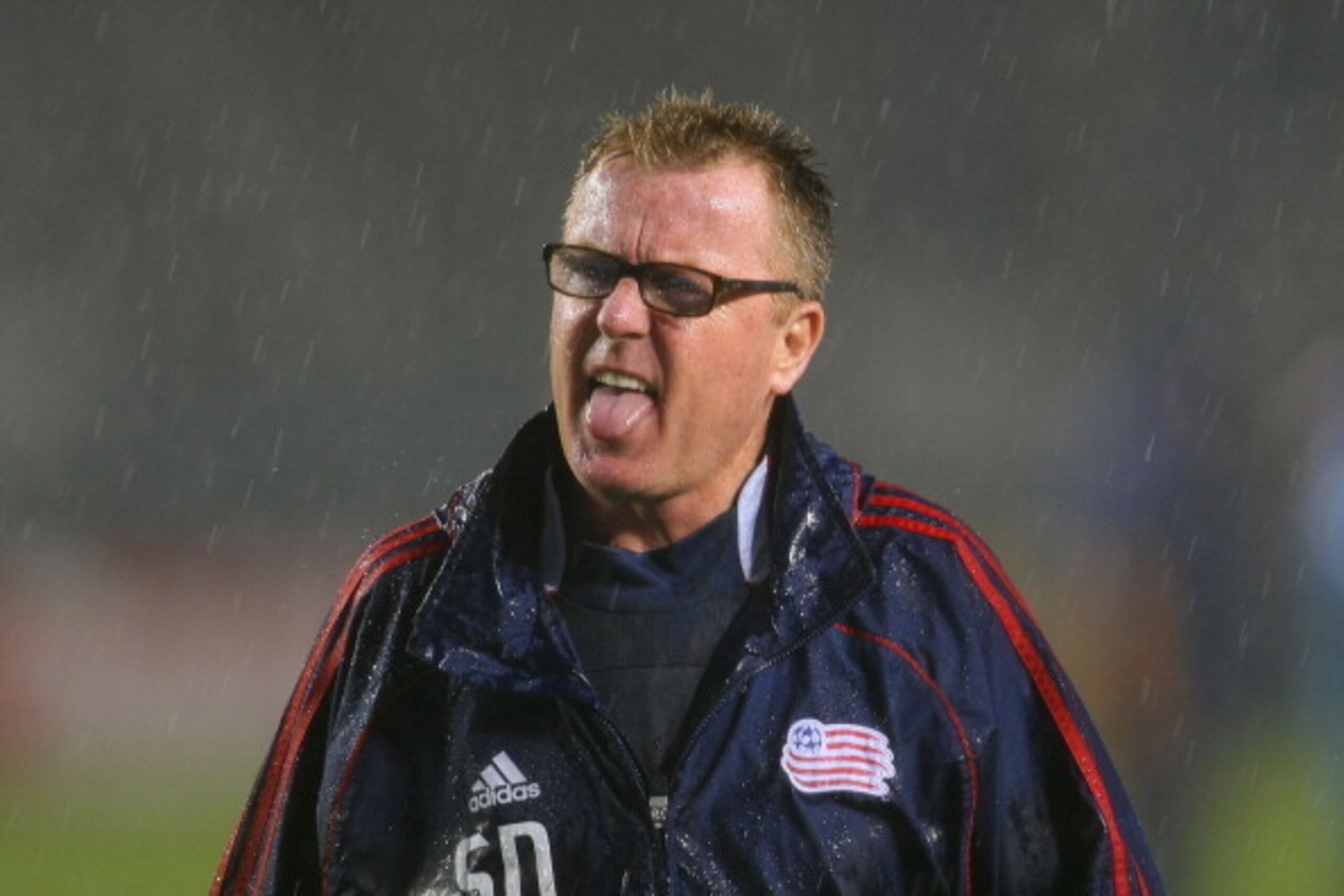CARSON, CA - MARCH 20:  Head Coach Steve Nicol of the New England Revolution tastes a bit of rain on his tongue on the way to the locker room after their MLS match against the Los Angeles Galaxy at The Home Depot Center on March 20, 2011 in Carson, Califo