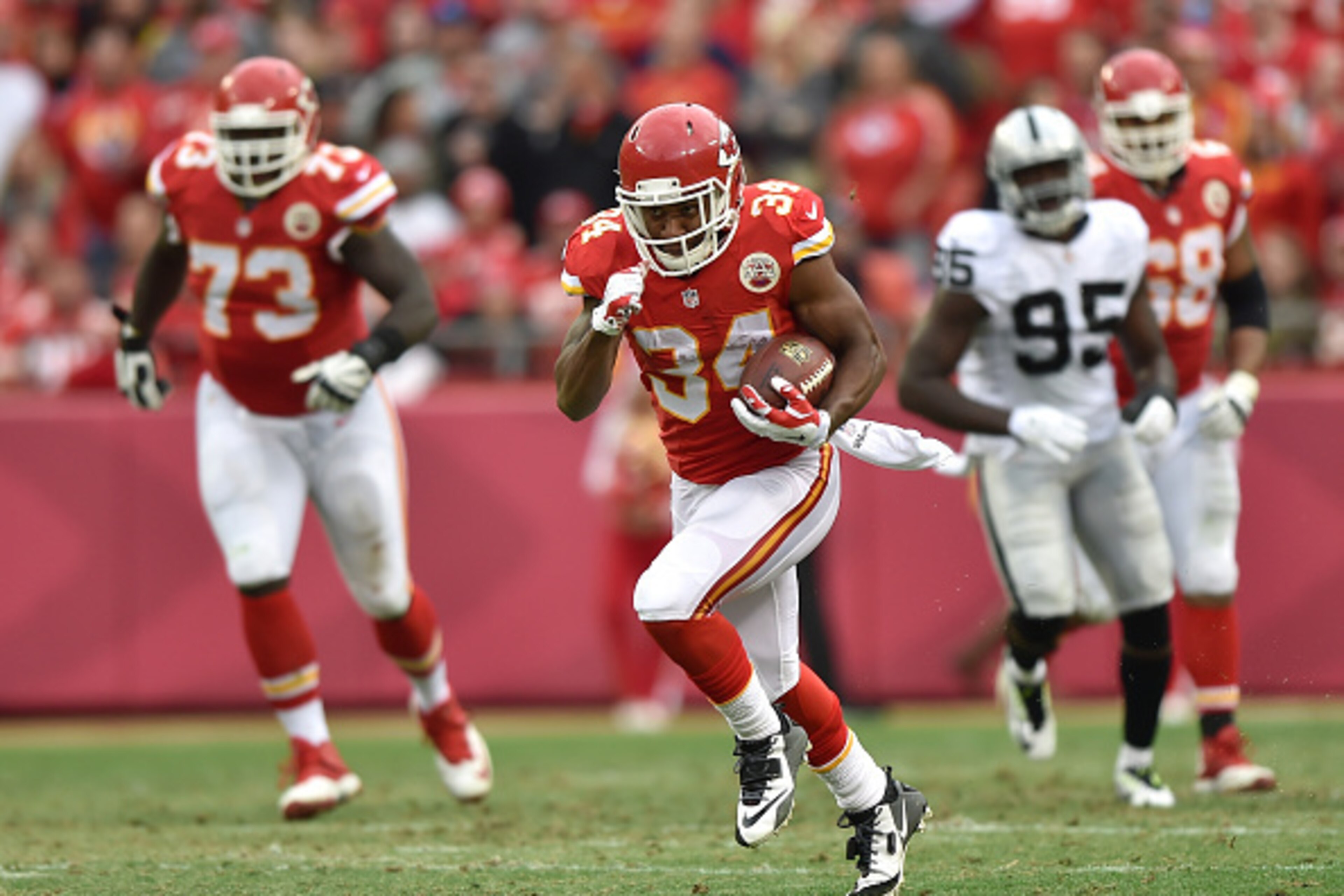 KANSAS CITY, MO - DECEMBER 14:   Knile Davis #34 of the Kansas City Chiefs runs the ball for a touchdown against the Oakland Raiders in the third quarter at Arrowhead Stadium on December 14, 2014 in Kansas City, Missouri.  (Photo by Peter Aiken/Getty Imag