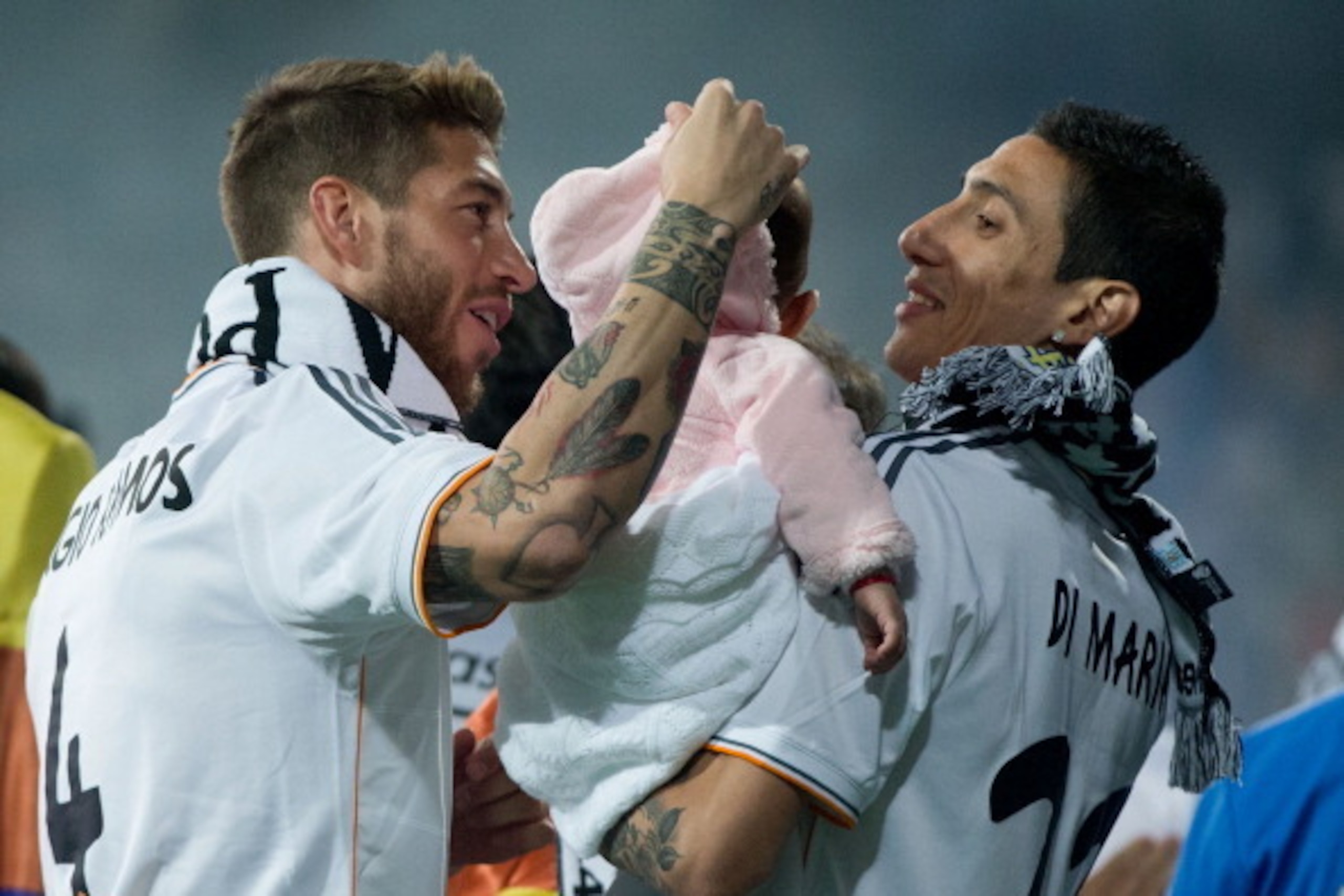 MADRID, SPAIN - MAY 25:  Sergio Ramos (L) of Real Madrid CF is shown with teammate Angel Di Maria and his daughter during the Real Madrid celebration the day after winning the UEFA Champions League Final at Santiago Bernabeu stadium on May 25, 2014 in Mad