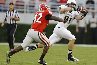 ATHENS, GA - OCTOBER 04:  Tight end Steven Scheu #81 of the Vanderbilt Commodores catches a pass against linebacker Tim Kimbrough #42 of the Georgia Bulldogs during the game at Sanford Stadium on October 4, 2014 in Athens, Georgia.  (Photo by Mike Zarrill