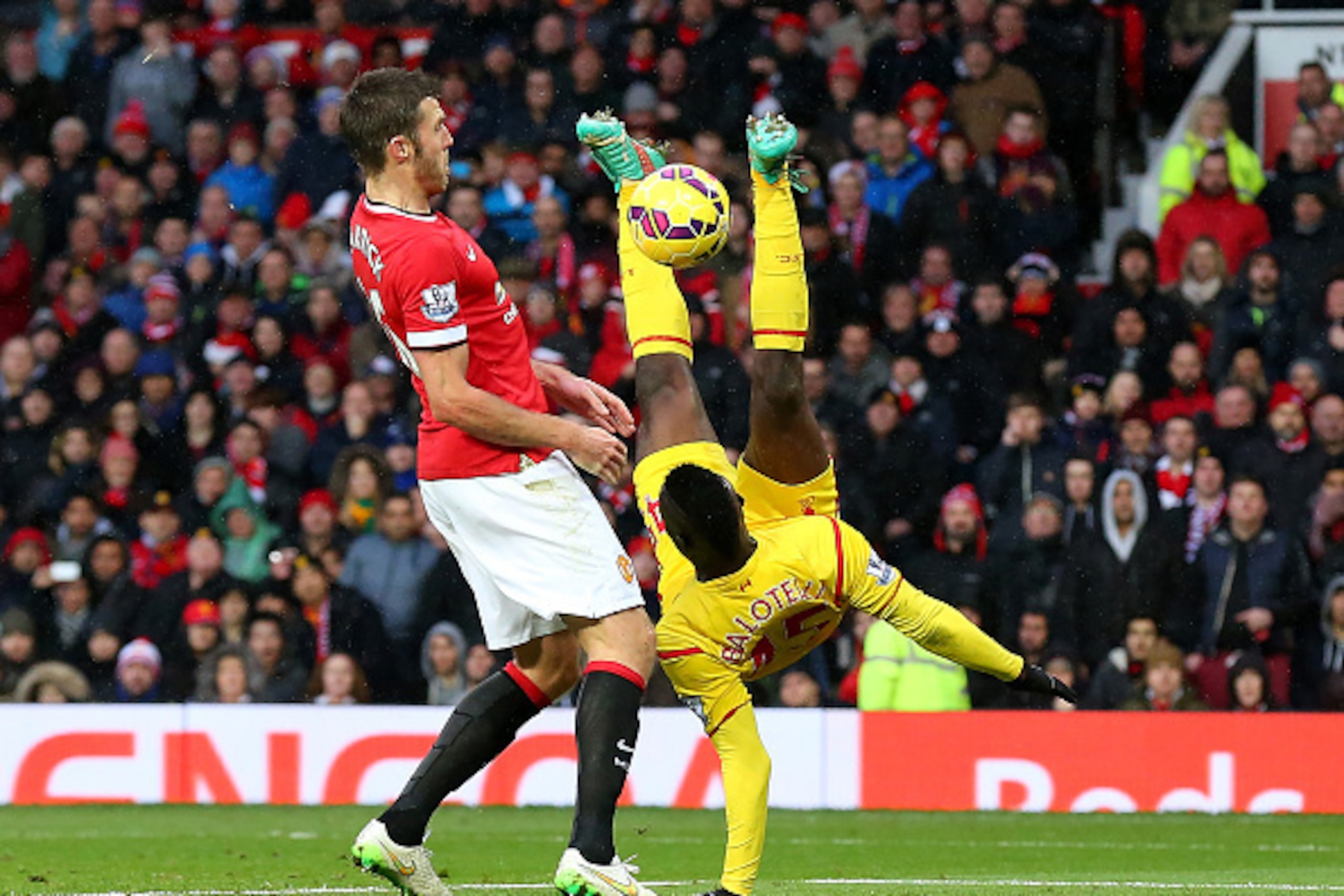 MANCHESTER, ENGLAND - DECEMBER 14: Mario Balotelli of Liverpool performs an overhead kick during the Barclays Premier League match between Manchester United and Liverpool at Old Trafford on December 14, 2014 in Manchester, England. (Photo by Alex Livese MANCHESTER, ENGLAND - DECEMBER 14: Mario Balotelli of Liverpool performs an overhead kick during the Barclays Premier League match between Manchester United and Liverpool at Old Trafford on December 14, 2014 in Manchester, England. (Photo by Alex Livese