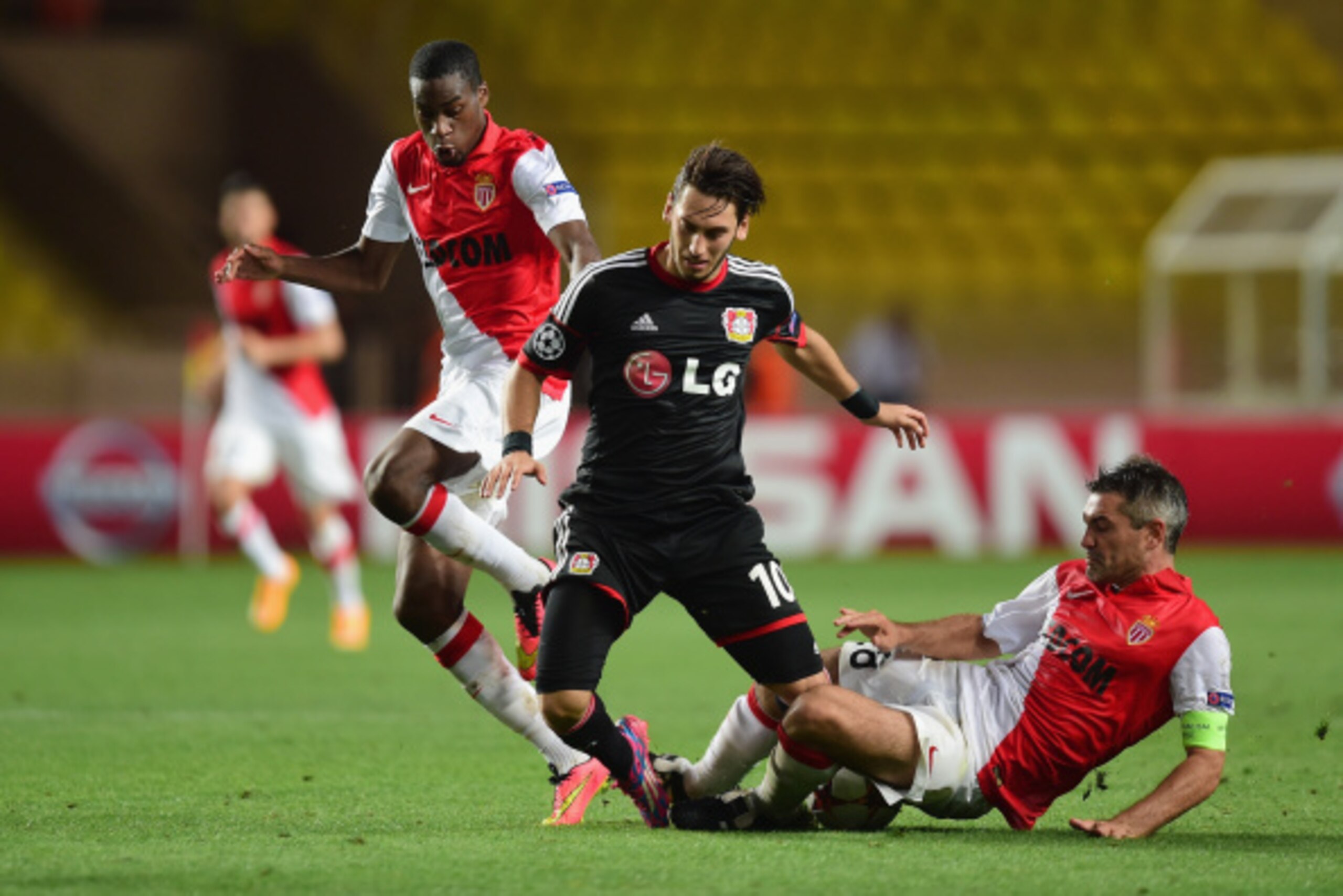 MONACO - SEPTEMBER 16:  Jeremy Toulalan of Monaco tackles Hakan Calhanoglu of Bayer Leverkusen during the UEFA Champions League Group C match between AS Monaco FC and Bayer 04 Leverkusen at Louis II Stadium on September 16, 2014 in Monaco, Monaco.  (Photo