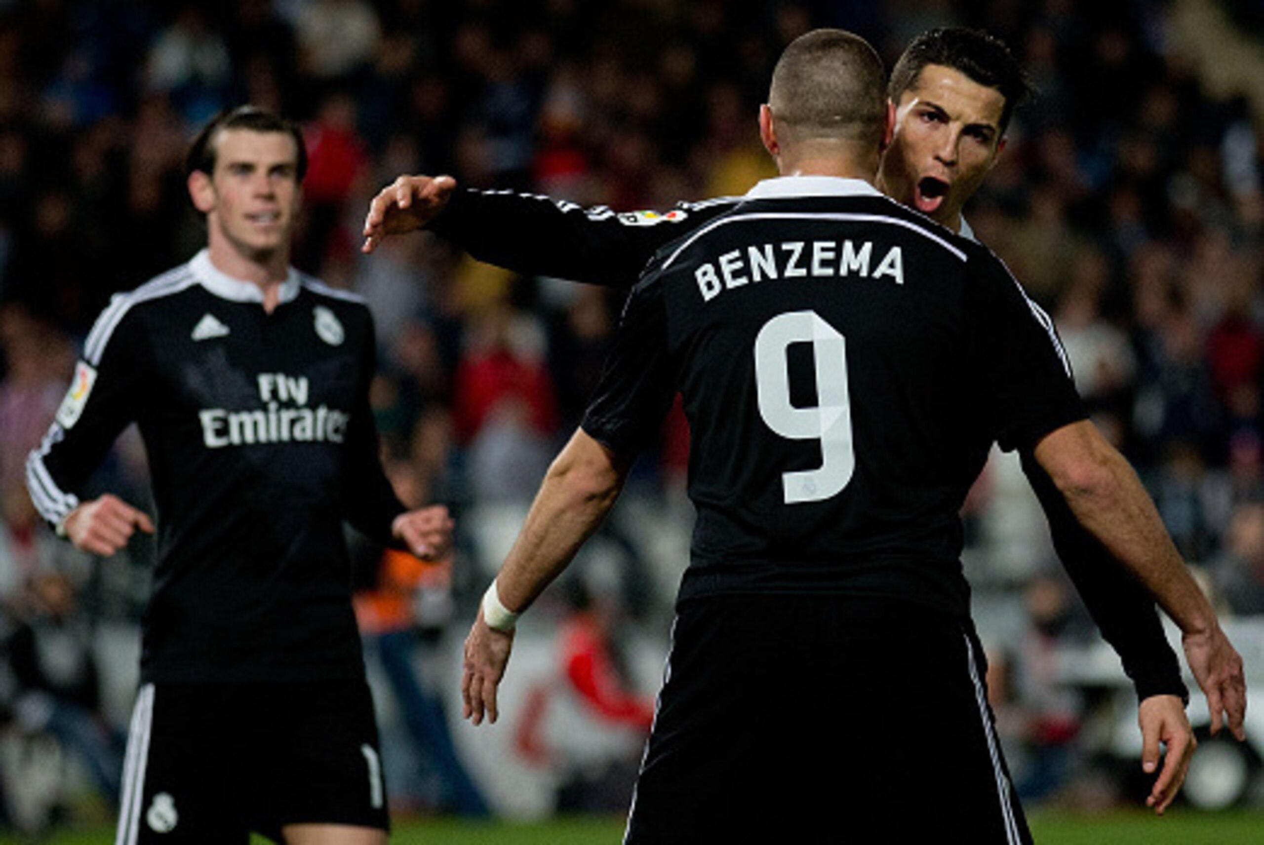 ALMERIA, SPAIN - DECEMBER 12: Cristiano Ronaldo (R) of Real Madrid CF celebrates scoring their third goal with teammate Karim Benzema (L) as Gareth Bale (L) runs to them during the La Liga match between UD Almeria and Real Madrid CF at Juegos del Mediter ALMERIA, SPAIN - DECEMBER 12: Cristiano Ronaldo (R) of Real Madrid CF celebrates scoring their third goal with teammate Karim Benzema (L) as Gareth Bale (L) runs to them during the La Liga match between UD Almeria and Real Madrid CF at Juegos del Mediter