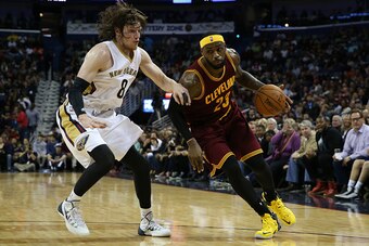 NEW ORLEANS, LA - DECEMBER 12:  LeBron James #23 of the Cleveland Cavaliers drives the ball around Luke Babbitt #8 of the New Orleans Pelicans  at Smoothie King Center on December 12, 2014 in New Orleans, Louisiana.  NOTE TO USER: User expressly acknowled