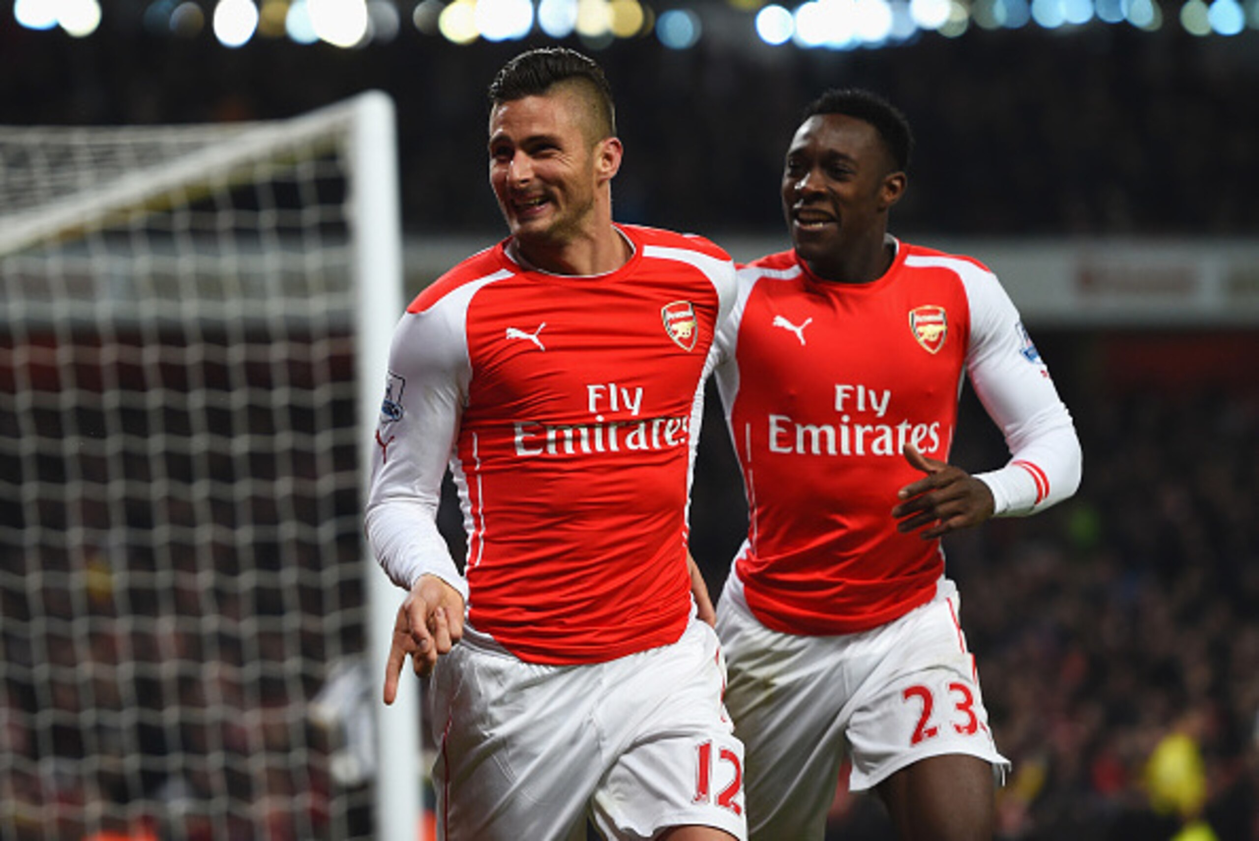 LONDON, ENGLAND - DECEMBER 13:  Olivier Giroud of Arsenal celebrates scoring his team's third goal with Danny Welbeck during the Barclays Premier League match between Arsenal and Newcastle United at Emirates Stadium on December 13, 2014 in London, England