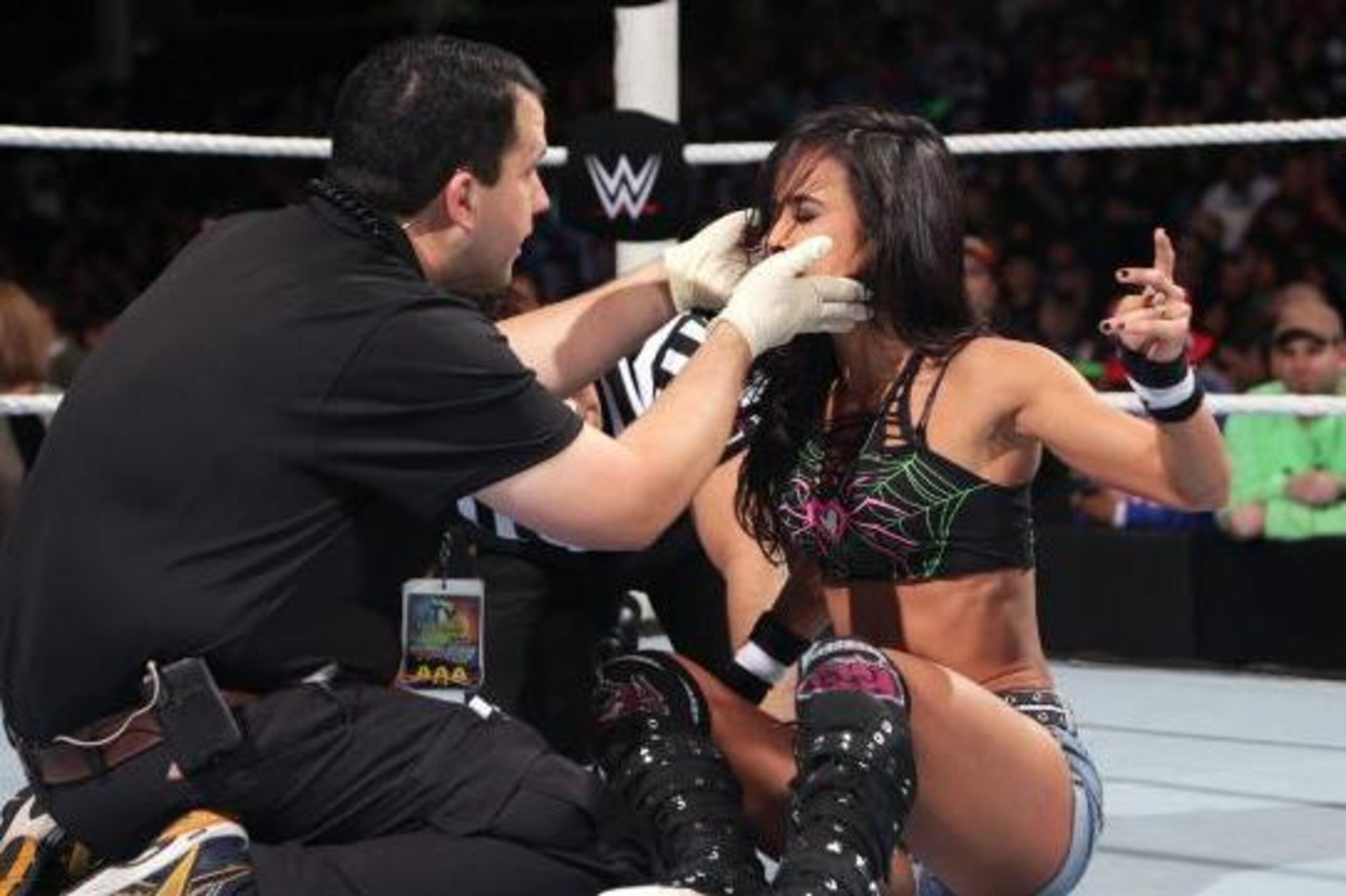 Medical staff attends to AJ Lee.