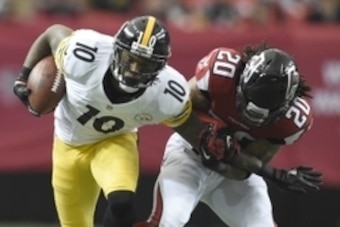 Dec 14, 2014; Atlanta, GA, USA; Pittsburgh Steelers wide receiver Martavis Bryant (10) carries the ball as he is tackled by Atlanta Falcons free safety Dwight Lowery (20) at the Georgia Dome. Mandatory Credit: RVR Photos-USA TODAY Sports
