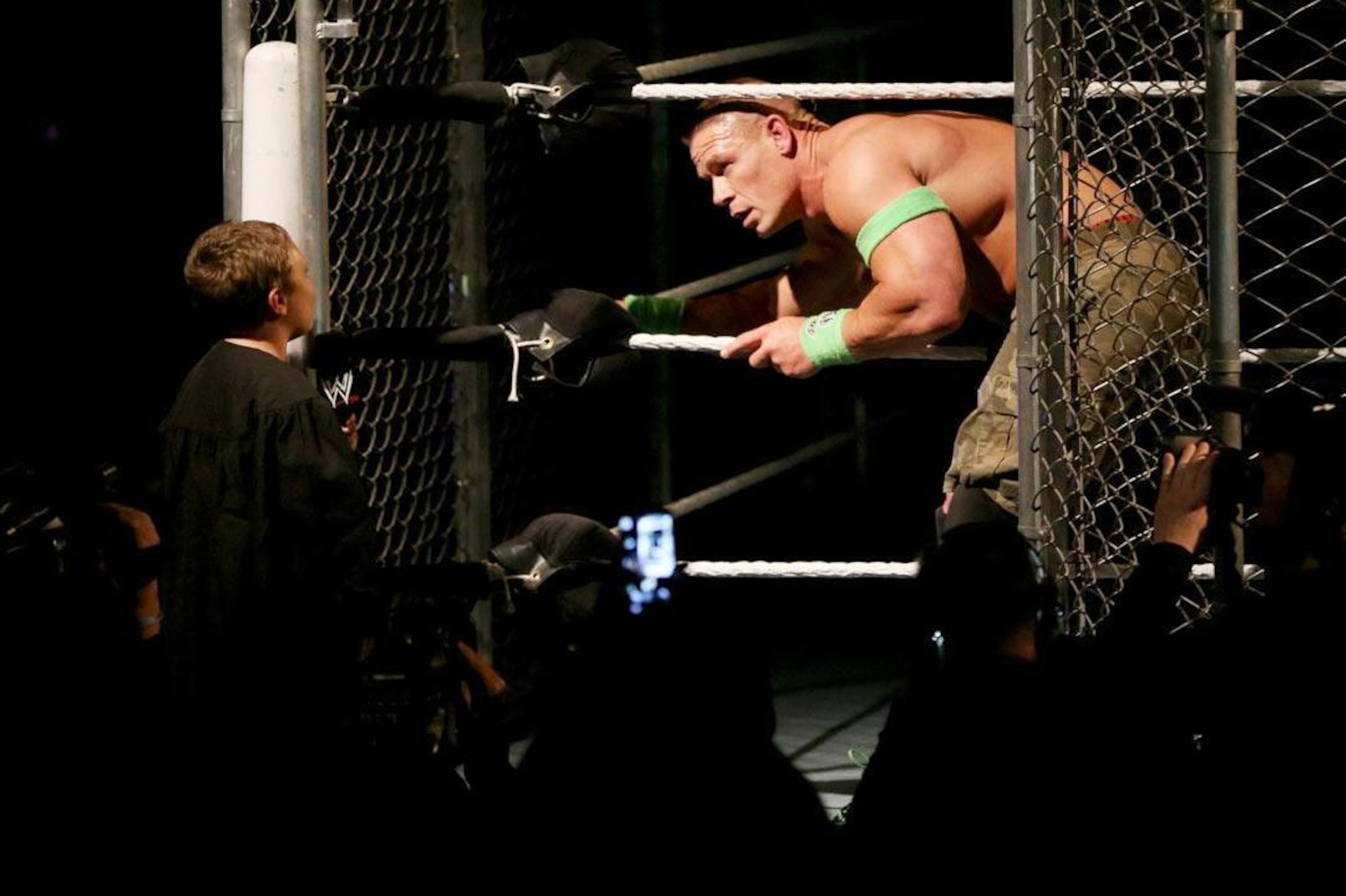 A young boy distracts John Cena.