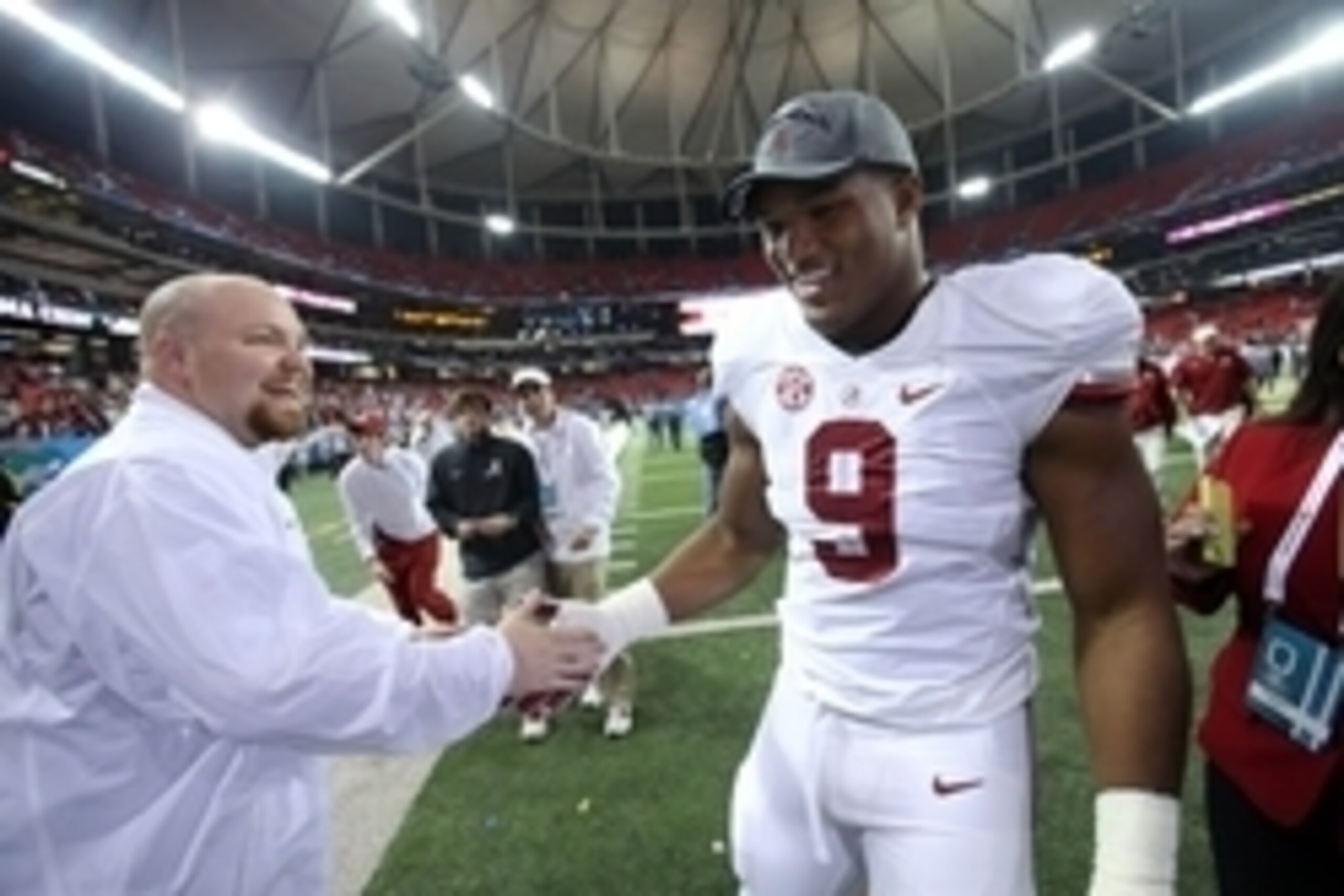 Dec 6, 2014; Atlanta, GA, USA; Alabama Crimson Tide defensive lineman Da'Shawn Hand (9) celebrates with a team member after Alabama defeated the Missouri Tigers in the 2014 SEC Championship at the Georgia Dome. Alabama beat Missouri 42-13. Mandatory Credi