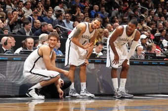 BROOKLYN, NY - JANUARY 5: Brook Lopez #11, Deron Williams #8 and Joe Johnson #7 of the Brooklyn Nets get ready to check in against the Sacramento Kings on January 5, 2013 at the Barclays Center in the Brooklyn borough of New York City.  NOTE TO USER: User