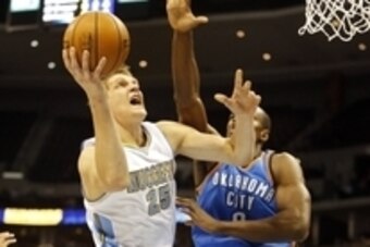 Nov 19, 2014; Denver, CO, USA; Denver Nuggets center Timofey Mozgov (25) is fouled by Oklahoma City Thunder forward Serge Ibaka (9) as he shoots the ball during the first half at Pepsi Center. Mandatory Credit: Chris Humphreys-USA TODAY Sports