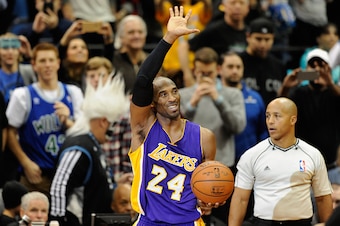 MINNEAPOLIS, MN - DECEMBER 14: Kobe Bryant #24 of the Los Angeles Lakers waves to the crowd after passing Michael Jordan on the all-time scoring list with a free throw in the second quarter of the game on December 14, 2014 at Target Center in Minneapolis,