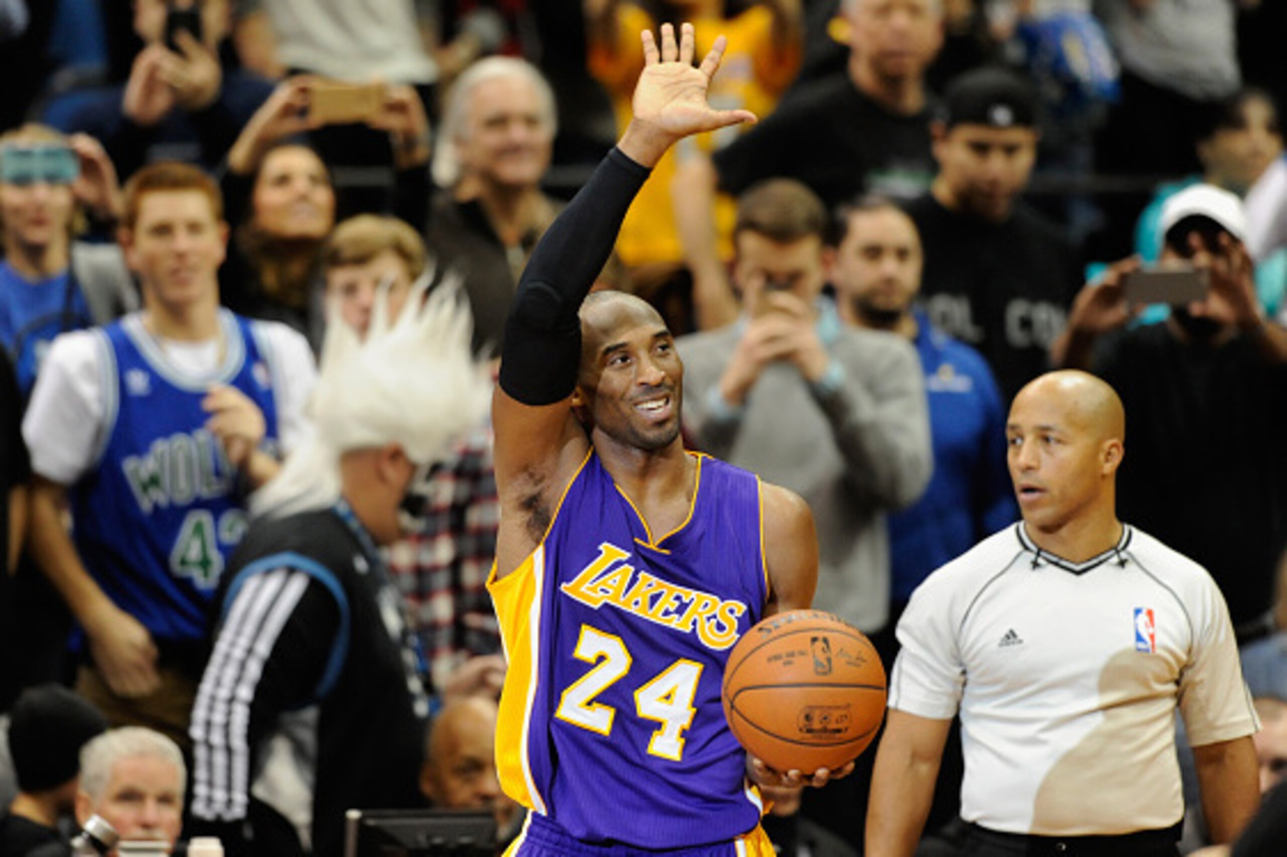MINNEAPOLIS, MN - DECEMBER 14: Kobe Bryant #24 of the Los Angeles Lakers waves to the crowd after passing Michael Jordan on the all-time scoring list with a free throw in the second quarter of the game on December 14, 2014 at Target Center in Minneapolis,