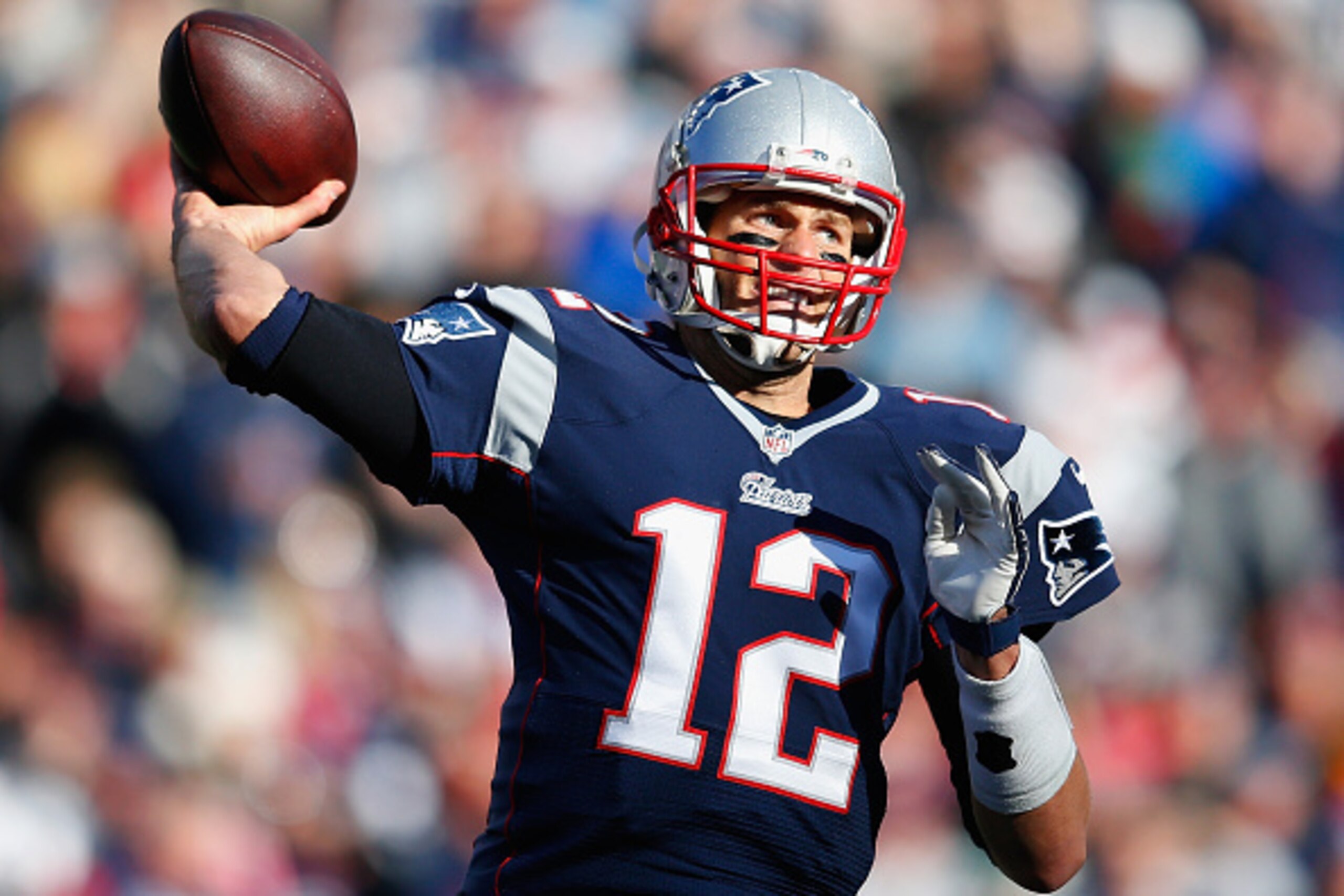 FOXBORO, MA - DECEMBER 14:  Tom Brady #12 of the New England Patriots passes the ball during the first quarter against the Miami Dolphins at Gillette Stadium on December 14, 2014 in Foxboro, Massachusetts.  (Photo by Jim Rogash/Getty Images)