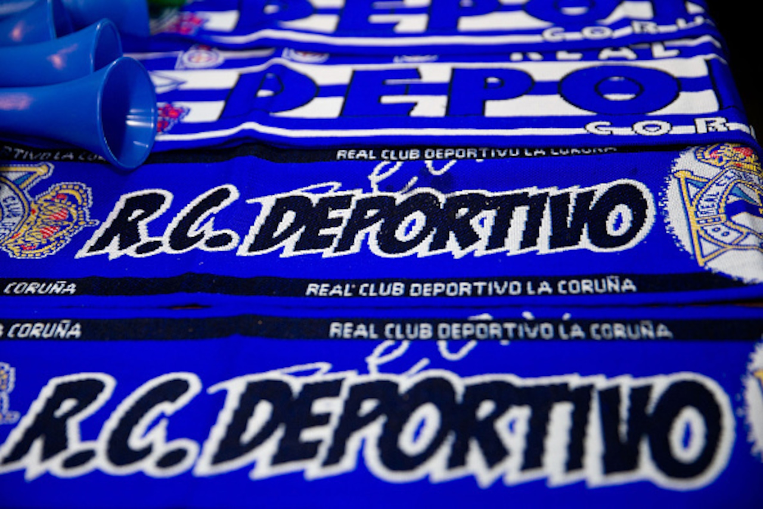 LA CORUNA, SPAIN - NOVEMBER 22:  Scarfs of RC Deportivo La Coruna are displayed at merchandise stall before the La Liga match between RC Deportivo La Coruna and Real Sociedad de Futbol at Riazor Stadium outdoors on November 22, 2014 in La Coruna, Spain.  