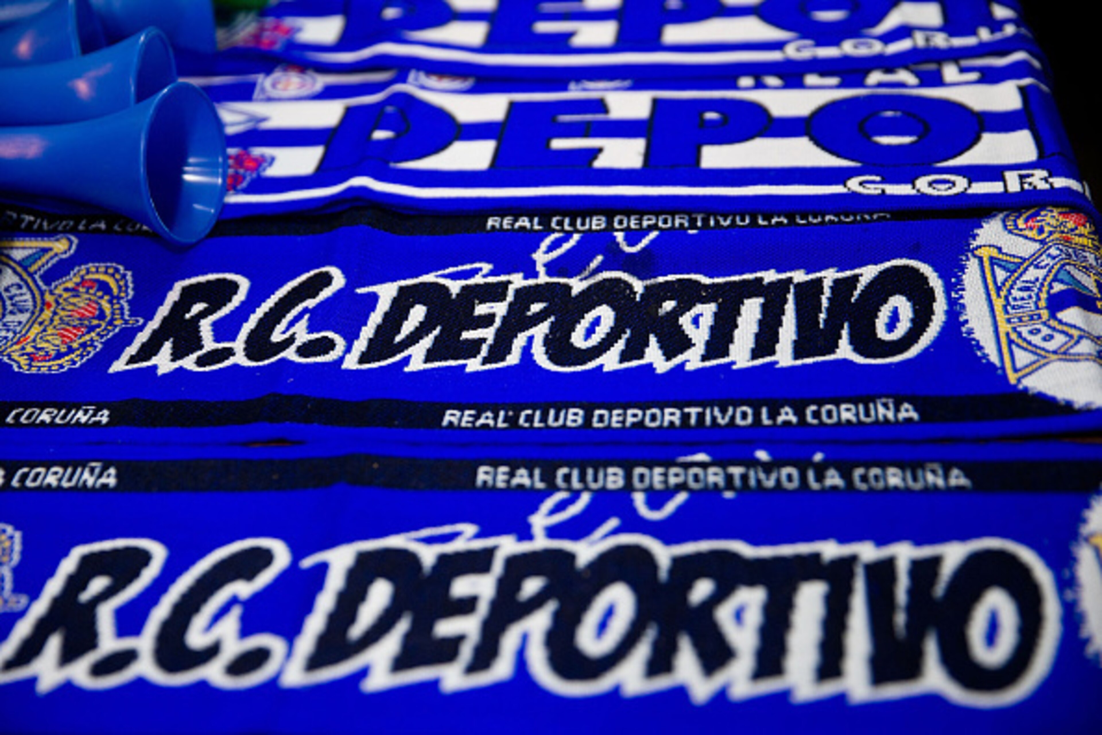 LA CORUNA, SPAIN - NOVEMBER 22: Scarfs of RC Deportivo La Coruna are displayed at merchandise stall before the La Liga match between RC Deportivo La Coruna and Real Sociedad de Futbol at Riazor Stadium outdoors on November 22, 2014 in La Coruna, Spain. LA CORUNA, SPAIN - NOVEMBER 22: Scarfs of RC Deportivo La Coruna are displayed at merchandise stall before the La Liga match between RC Deportivo La Coruna and Real Sociedad de Futbol at Riazor Stadium outdoors on November 22, 2014 in La Coruna, Spain.