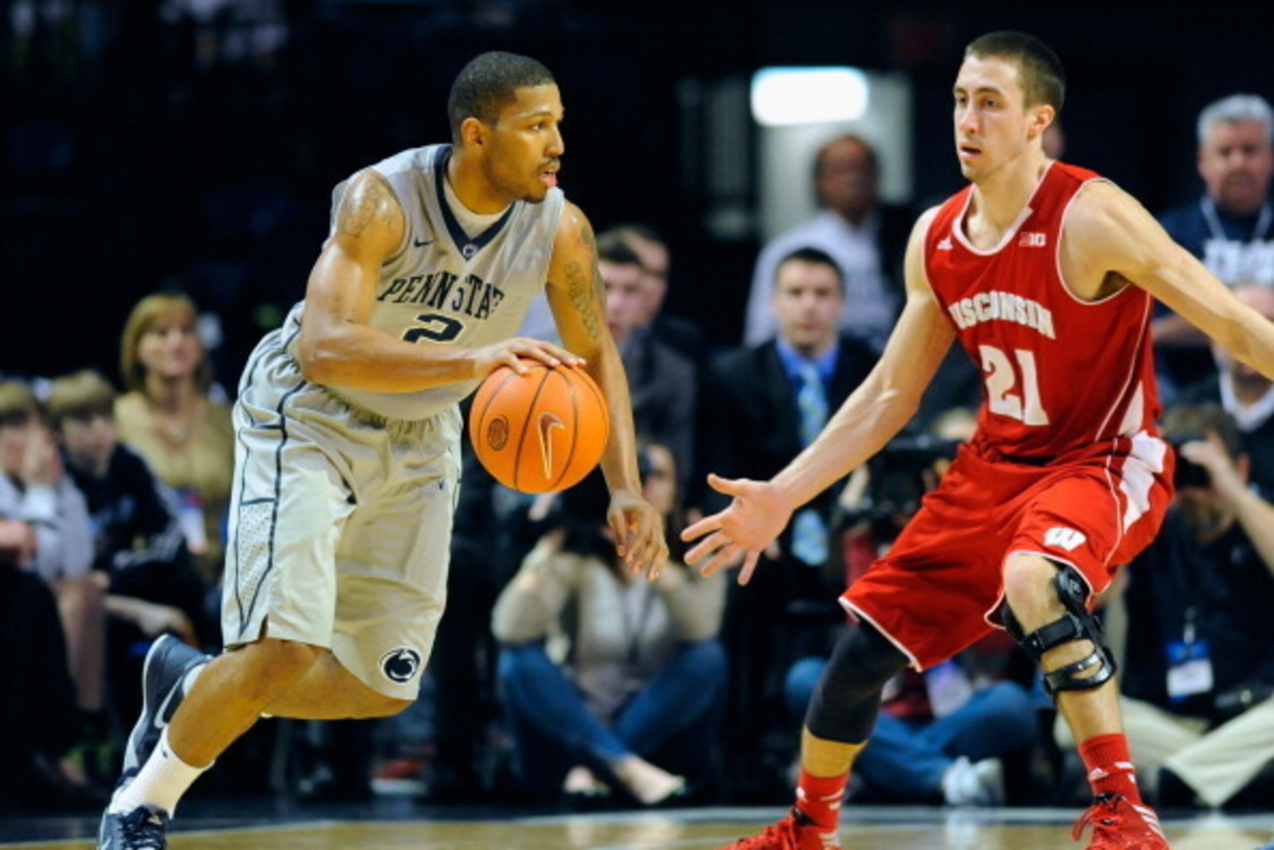 UNIVERSITY PARK, PA - MARCH 02:  D.J. Newbill #2 of the Penn State Nittany Lions drives to the basket around the defense of Josh Gasser #21 of the Wisconsin Badgers during the second half at the Bryce Jordan Center on March 2, 2014 in University Park, Pen