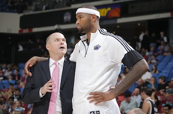 SACRAMENTO, CA - October 7: Head Coach of the Sacramento Kings Michael Malone speaks to DeMarcus Cousins #15 during a game against the Toronto Raptors at the Sleep Train Arena in Sacramento, California on October 7, 2014. NOTE TO USER: User expressly ackn