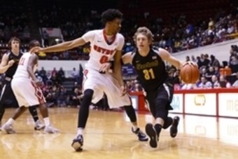 Dec 13, 2014; Detroit, MI, USA; Wichita State Shockers guard Ron Baker (31) moves the ball on Detroit Titans guard Chris Jenkins (0) in the first half at Calihan Hall. Mandatory Credit: Rick Osentoski-USA TODAY Sports