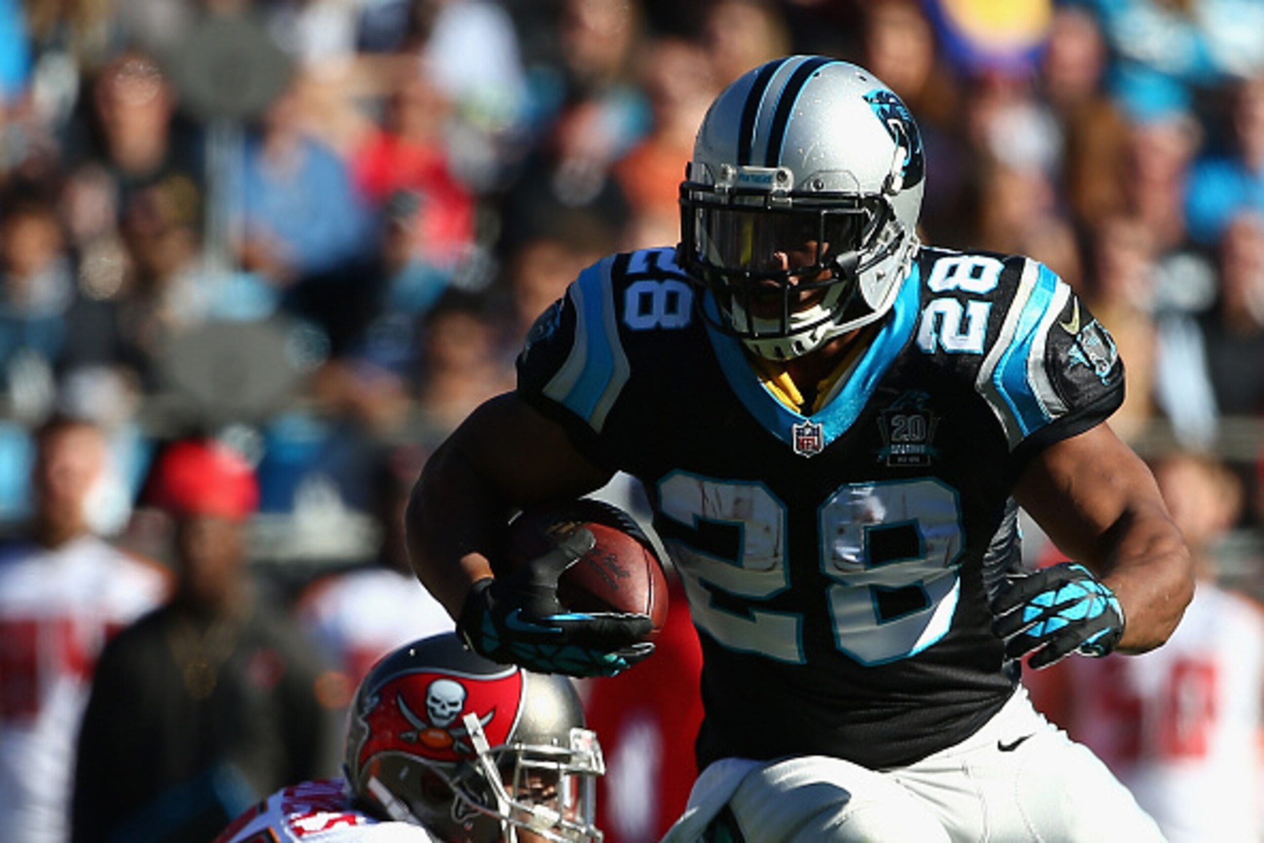 CHARLOTTE, NC - DECEMBER 14:  Jonathan Stewart #28 of the Carolina Panthers runs from  Da'Quan Bowers #91 of the Tampa Bay Buccaneers in the 1st quarter during their game at Bank of America Stadium on December 14, 2014 in Charlotte, North Carolina.  (Phot
