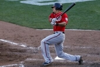 Oct 6, 2014; San Francisco, CA, USA; Washington Nationals shortstop Ian Desmond (20) hits a single during the seventh inning against the San Francisco Giants in game three of the 2014 NLDS baseball playoff game at AT&T Park. Mandatory Credit: Kelley L Cox