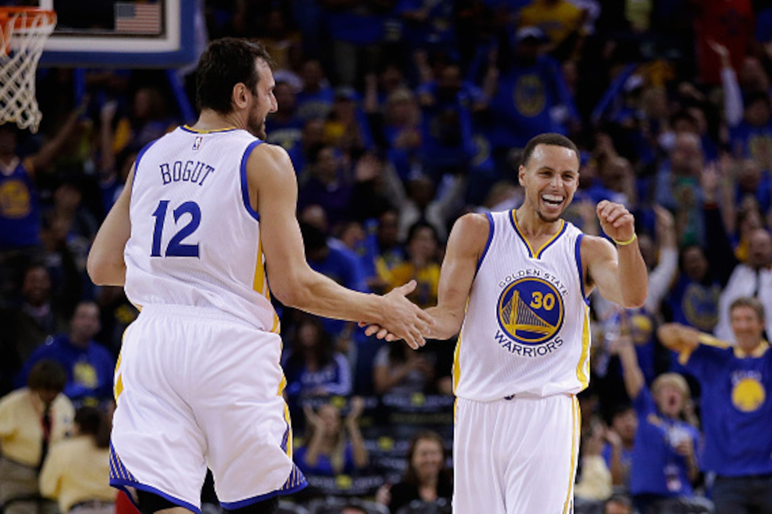 OAKLAND, CA - NOVEMBER 01:  Stephen Curry #30 of the Golden State Warriors reacts with Andrew Bogut #12 after he threw a long down court assist to Klay Thompson #11 who made a three-point basket against the Los Angeles Lakers at ORACLE Arena on November 1