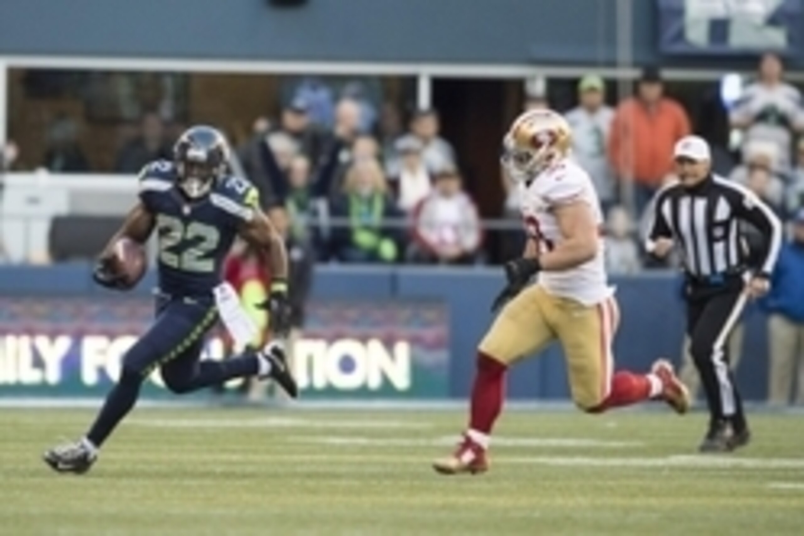 Dec 14, 2014; Seattle, WA, USA; Seattle Seahawks running back Robert Turbin (22) runs with the ball while being chased by San Francisco 49ers inside linebacker Chris Borland (50) during the first half at CenturyLink Field. Mandatory Credit: Steven Bisig-U