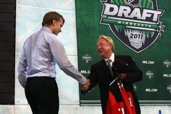 ST PAUL, MN - JUNE 24:  Fourth overall pick Adam Larsson by the New Jersey Devils shakes hands with scout David Conte of the New Jersey Devils at the podium during day one of the 2011 NHL Entry Draft at Xcel Energy Center on June 24, 2011 in St Paul, Minn