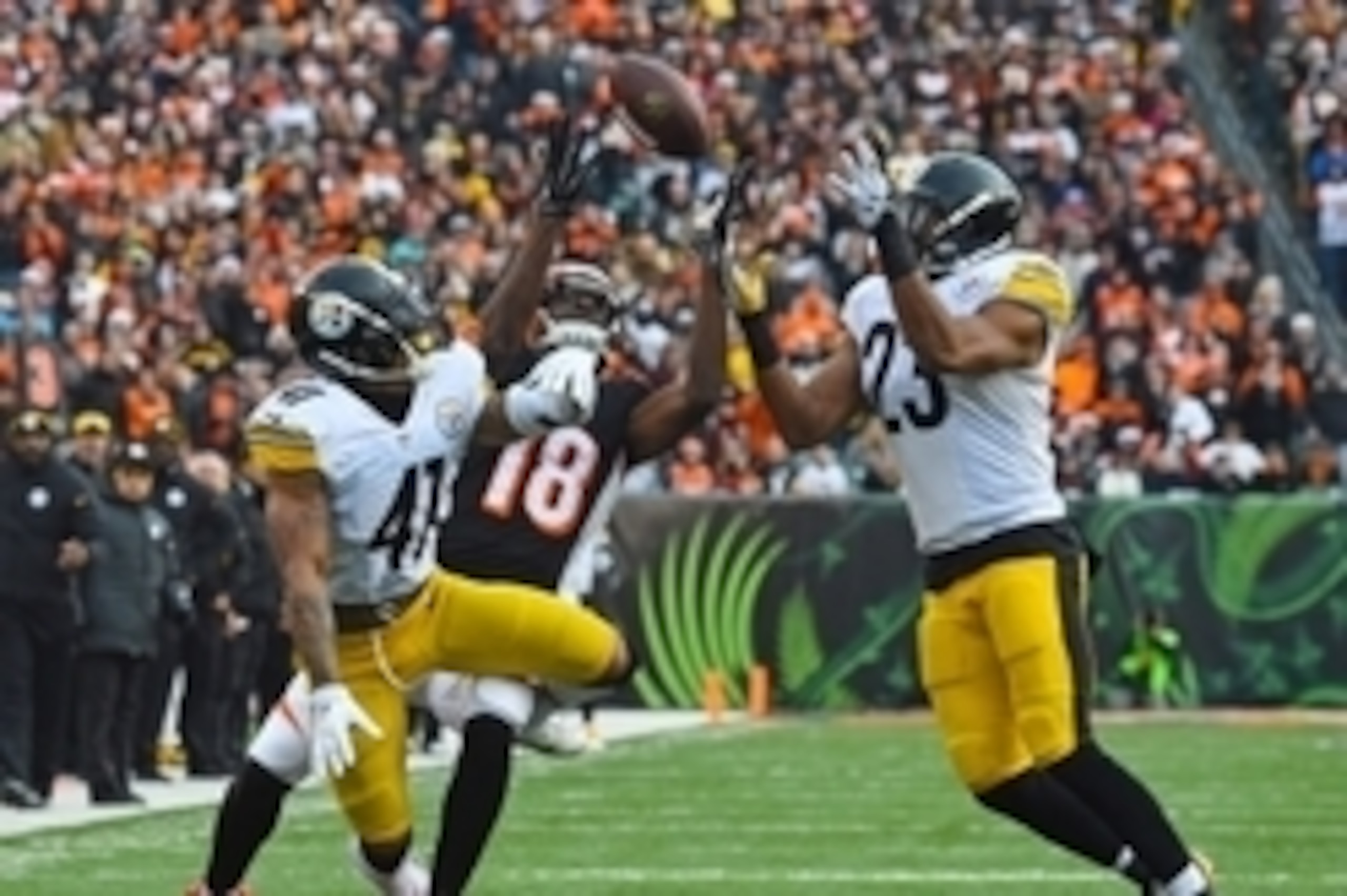 Dec 7, 2014; Cincinnati, OH, USA; Cincinnati Bengals wide receiver A.J. Green (18) attempts to make a catch against Pittsburgh Steelers defensive back Antwon Blake (41) and free safety Mike Mitchell (23) during the second half at Paul Brown Stadium. Pitts Dec 7, 2014; Cincinnati, OH, USA; Cincinnati Bengals wide receiver A.J. Green (18) attempts to make a catch against Pittsburgh Steelers defensive back Antwon Blake (41) and free safety Mike Mitchell (23) during the second half at Paul Brown Stadium. Pitts