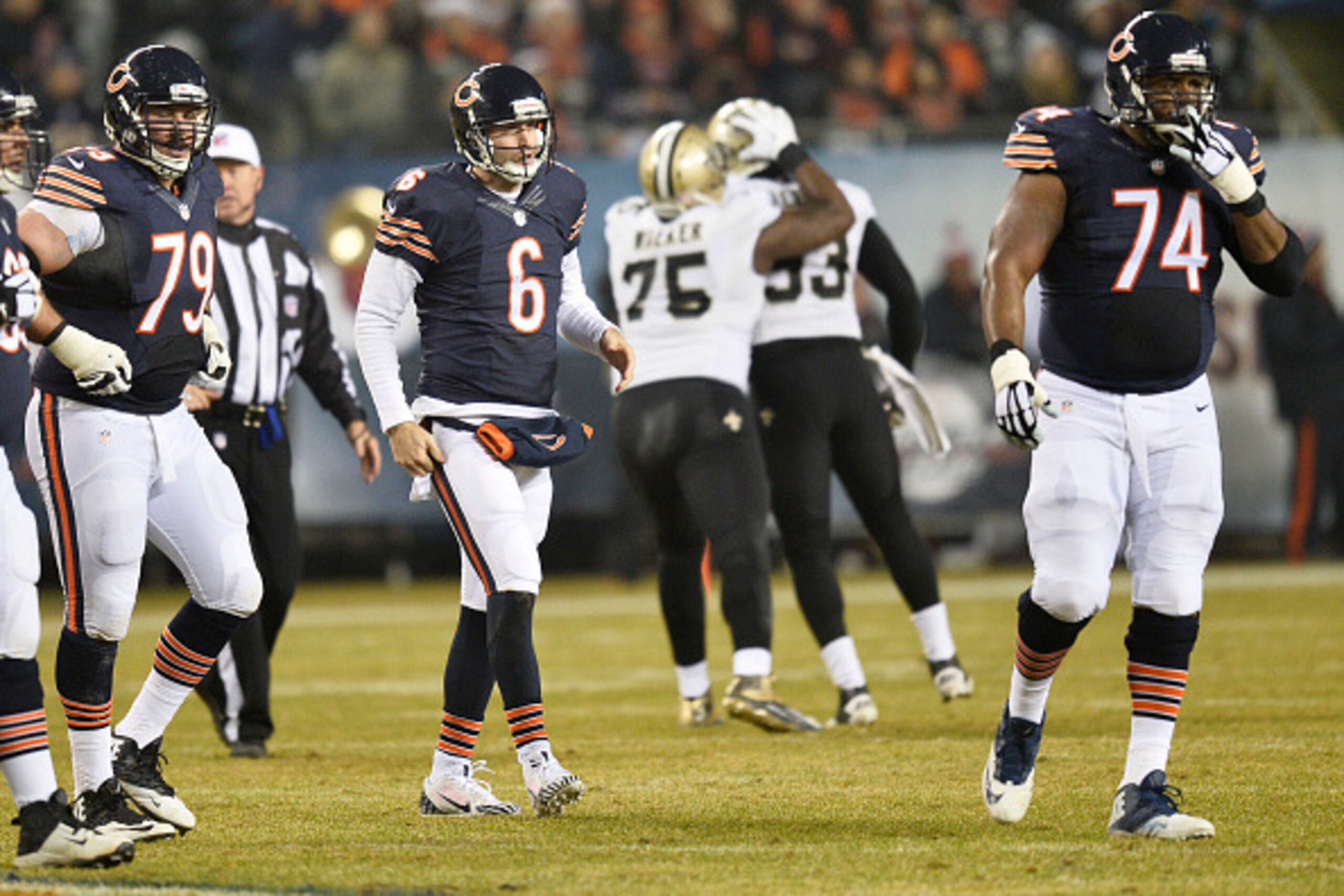 CHICAGO, IL - DECEMBER 15: Ryan Groy #79, Jay Cutler #6, and Jermon Bushrod #74 of the Chicago Bears walk off the field after a Cutler sack during the first quarter of a game against the New Orleans Saints at Soldier Field on December 15, 2014 in Chicago,