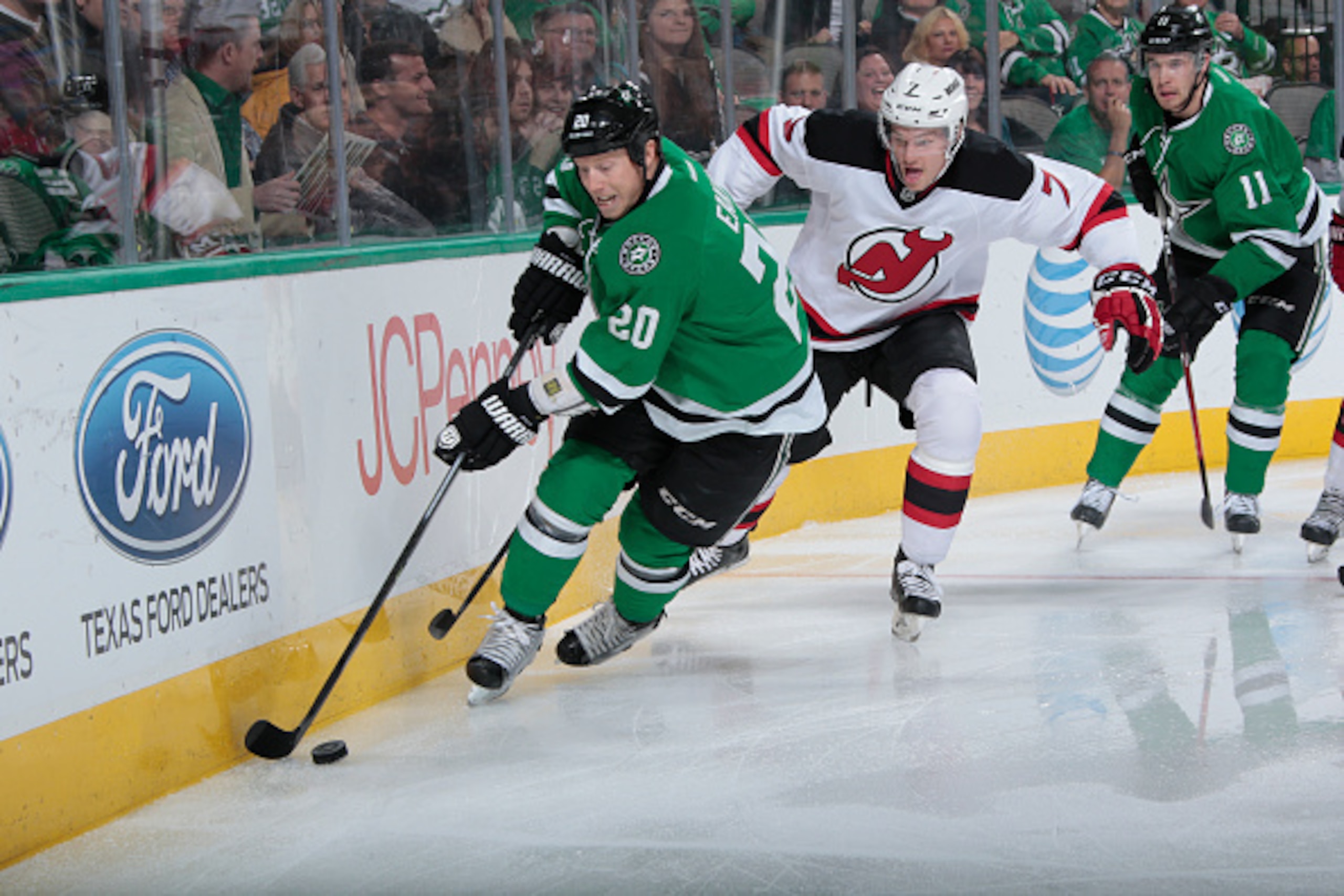 DALLAS, TX - DECEMBER 13: Cody Eakin #20 of the Dallas Stars handles the puck against Jon Merrill #7 of the New Jersey Devils at the American Airlines Center on December 13, 2014 in Dallas, Texas. (Photo by Glenn James/NHLI via Getty Images)