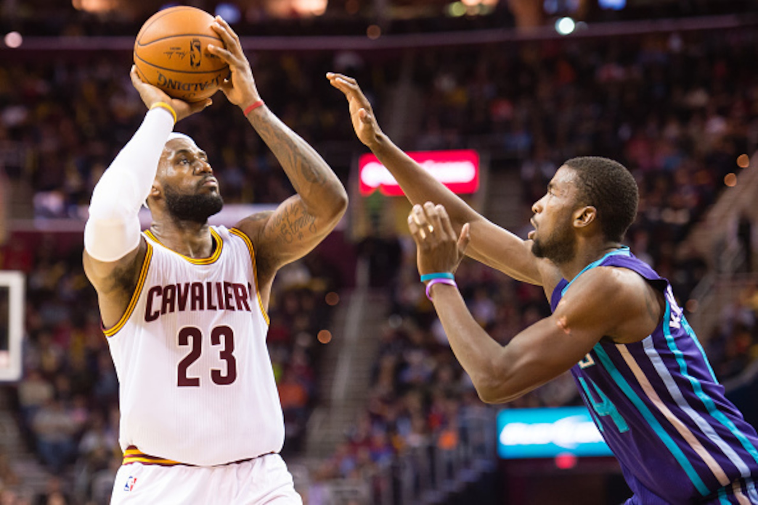CLEVELAND, OH - DECEMBER 15: LeBron James #23 of the Cleveland Cavaliers shoots over Michael Kidd-Gilchrist #14 of the Charlotte Hornets during the second half at Quicken Loans Arena on December 15, 2014 in Cleveland, Ohio. The Cavaliers defeated the Horn