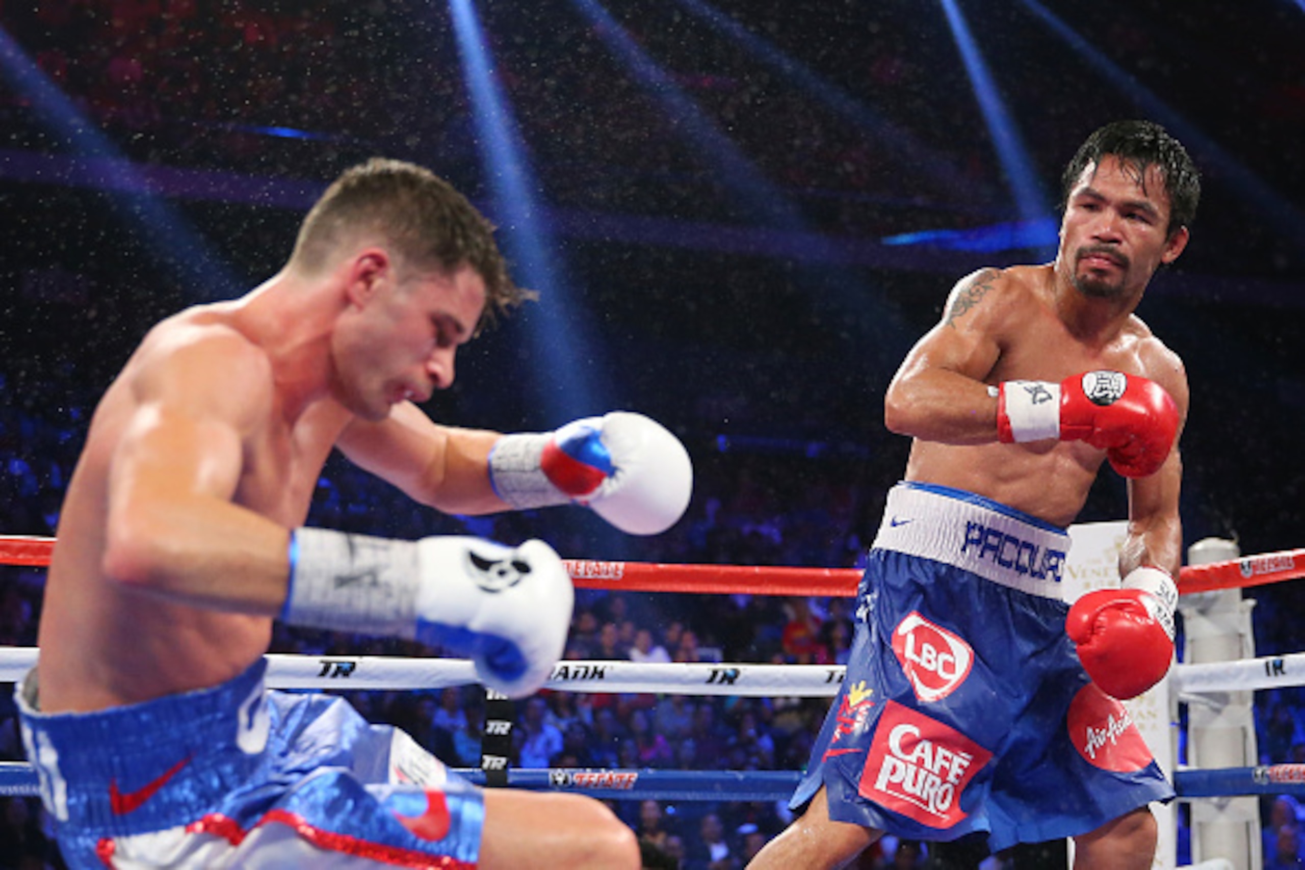 MACAU - NOVEMBER 23:  Manny Pacquiao of the Philippines knockes down Chris Algieri of the United States during the world welterweight title at The Venetian on November 23, 2014 in Macau, Macau.  (Photo by Chris Hyde/Getty Images)