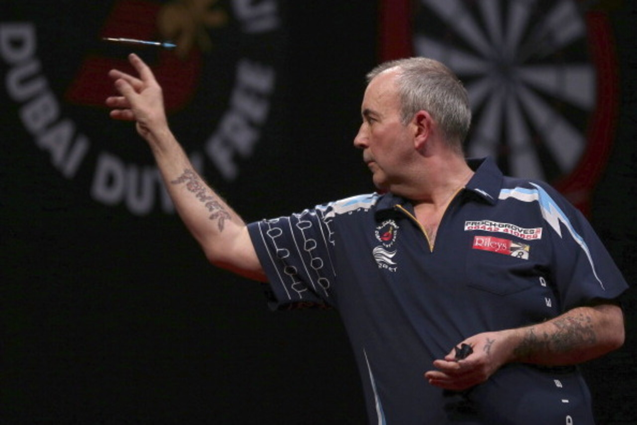 DUBAI, UNITED ARAB EMIRATES - MAY 29:  Phil Taylor of England plays against Peter Wright of England  during the 2014 Dubai Duty Free Darts Masters Quarter-Final match at Dubai Duty Free Tennis Stadium, Irish Village on May 29, 2014 in Dubai, United Arab E