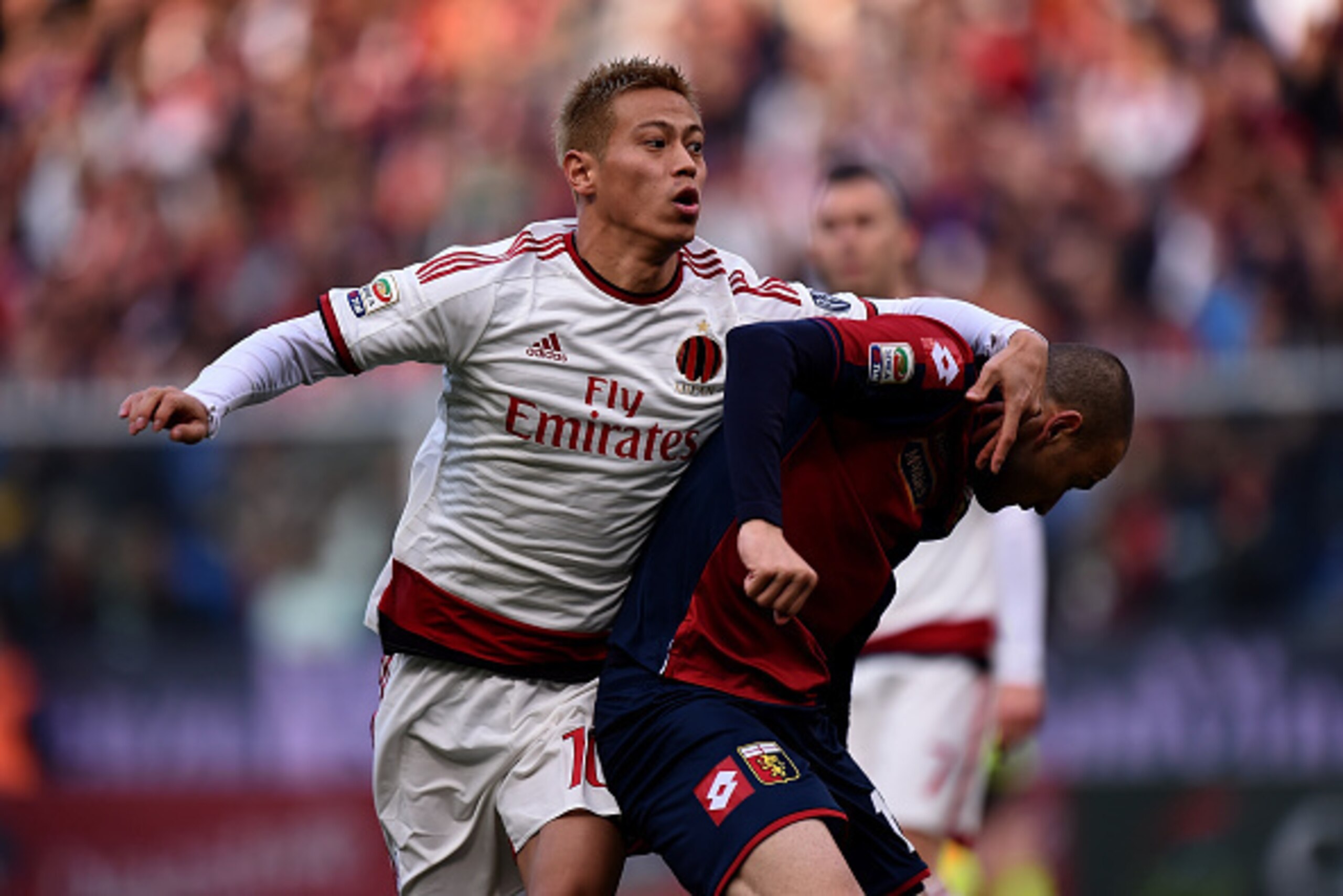 GENOA, ITALY - DECEMBER 07:  Keisuke Honda (L) of Milan and Luca Antonelli of Genoa compete for the ball during the Serie A match between Genoa CFC and AC Milan at Stadio Luigi Ferraris on December 7, 2014 in Genoa, Italy.  (Photo by Tullio M. Puglia/Gett