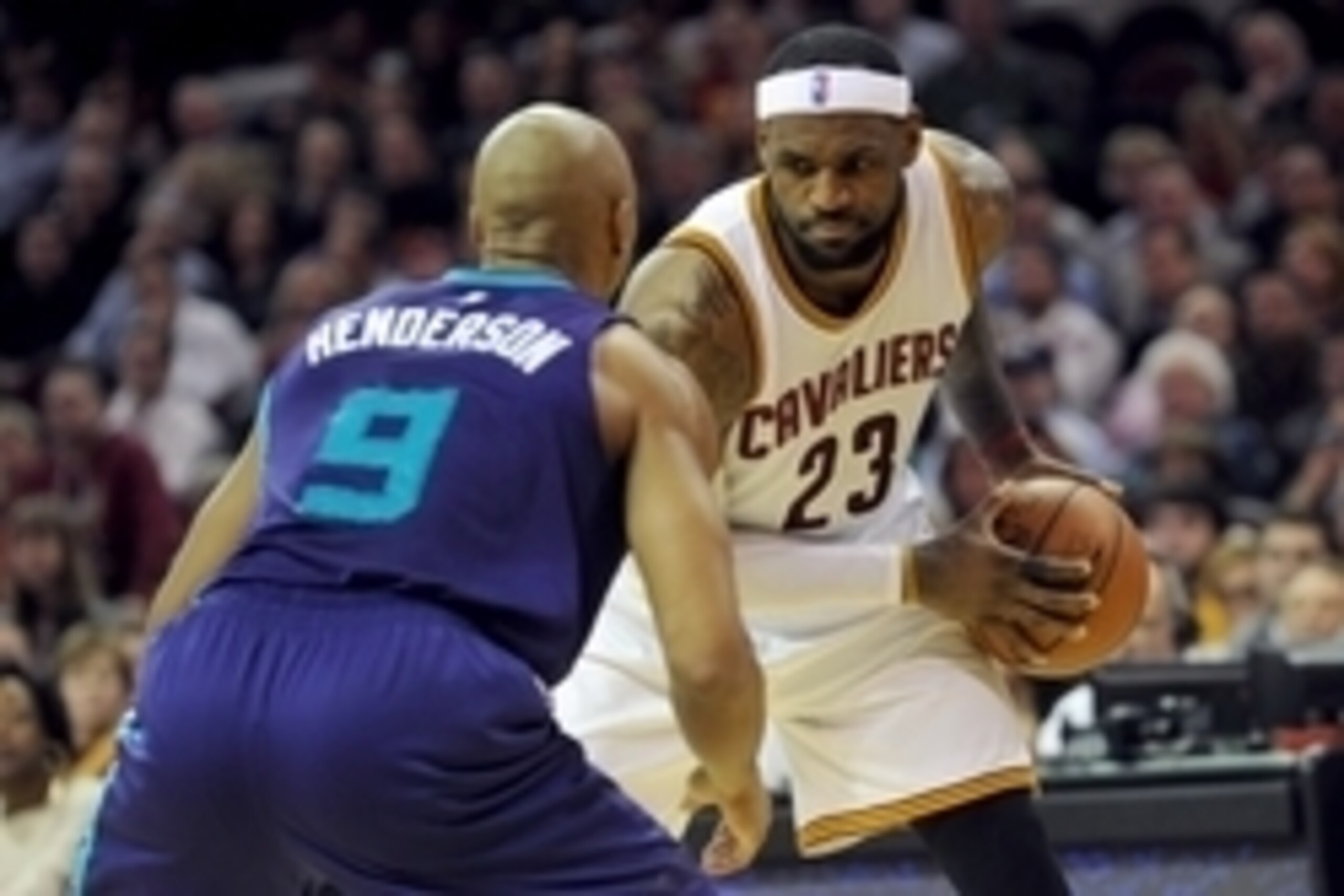 Dec 15, 2014; Cleveland, OH, USA; Cleveland Cavaliers forward LeBron James (23) works against Charlotte Hornets guard Gerald Henderson (9) during the fourth quarter at Quicken Loans Arena. The Cavs beat the Hornets 97-88. Mandatory Credit: Ken Blaze-USA T