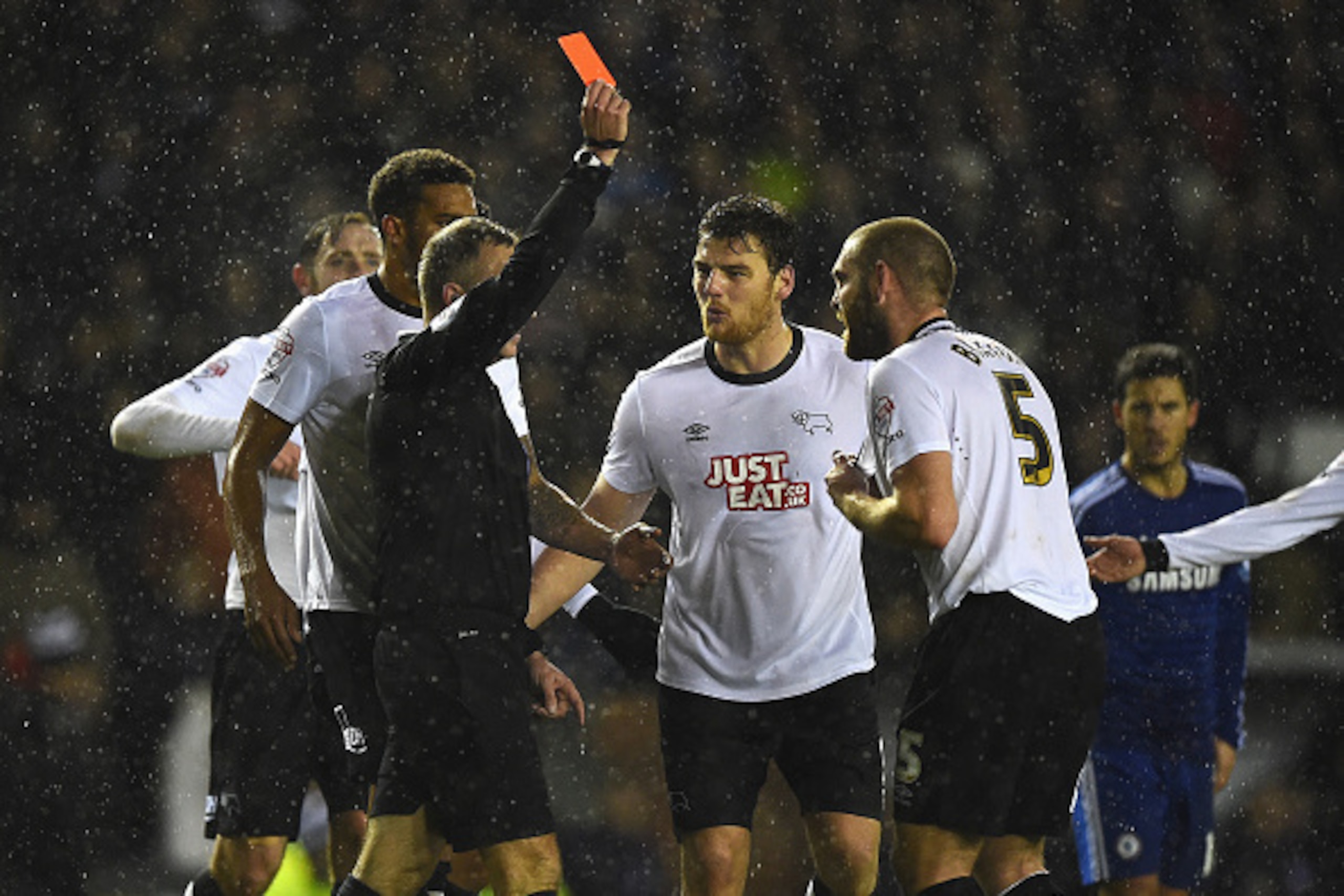 DERBY, ENGLAND - DECEMBER 16: Jake Buxton (R) of Derby is shown the red card by referee Jonathan Moss during the Capital One Cup Quarter-Final match between Derby County and Chelsea at Pride Park Stadium on December 16, 2014 in Derby, England.  (Photo by 