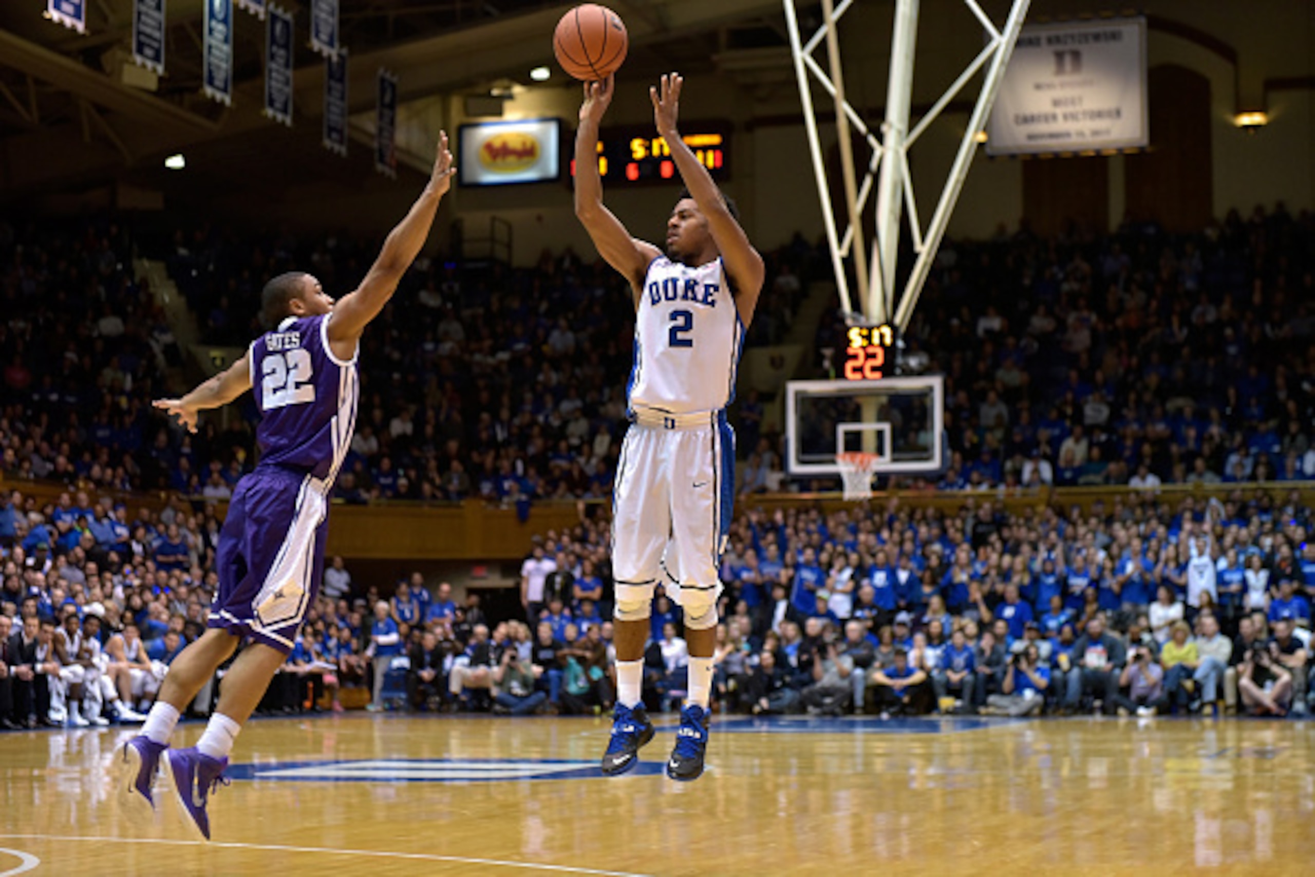 DURHAM, NC - NOVEMBER 26: Quinn Cook #2 of the Duke Blue Devils shoots over defender William Gates Jr. #22 of the Furman Paladins during their game at Cameron Indoor Stadium on November 26, 2014 in Durham, North Carolina. (Photo by Grant Halverson/Getty I