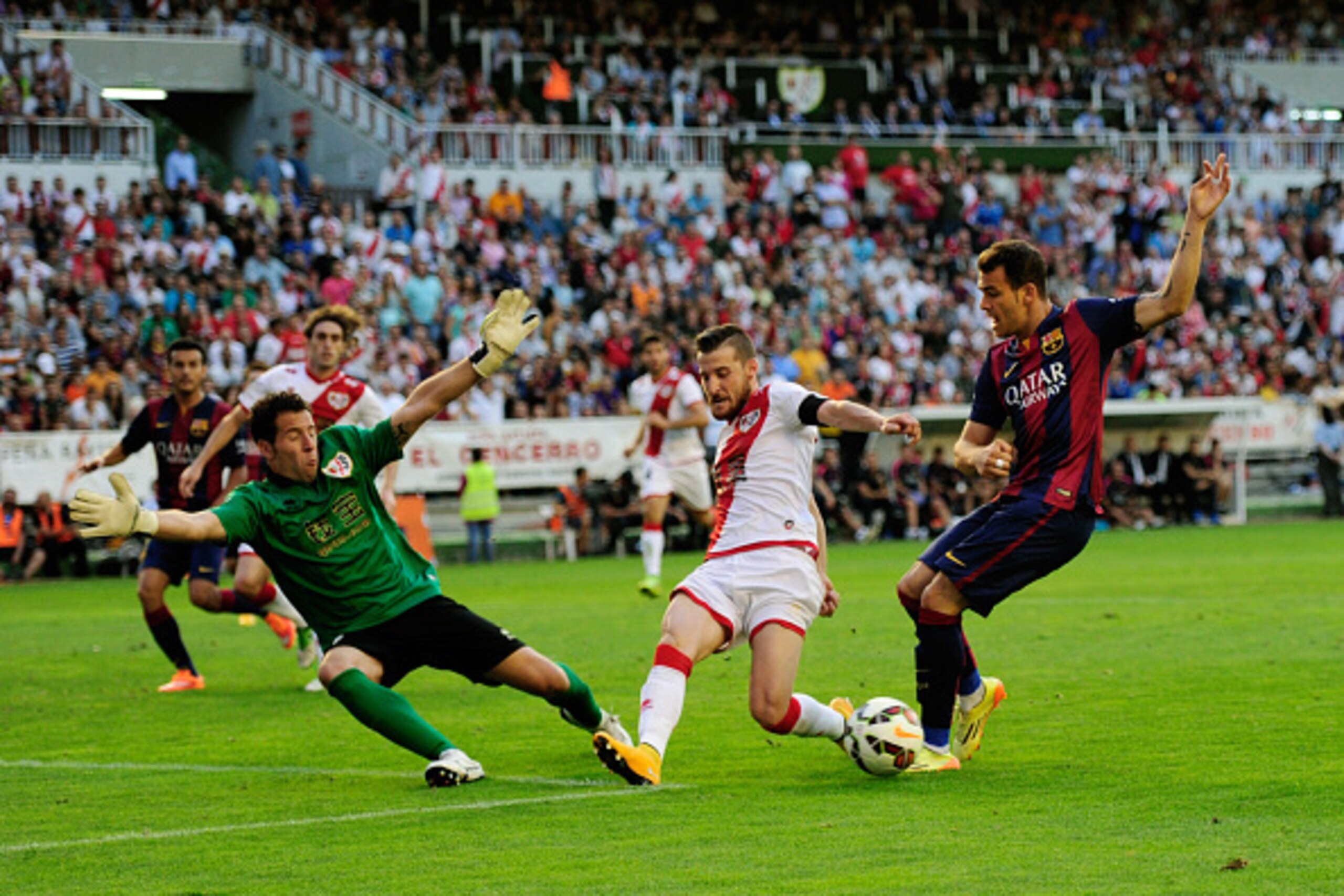 MADRID, SPAIN - OCTOBER 04:  Sandro Ramirez of FC Barcelona tries to shoot past Tono Rodriguez of Rayo Vallecano de Madrid to score his team's opening goal during the La Liga match between Rayo Vallecano de Madrid and FC Barcelona at Estadio Teresa Rivero