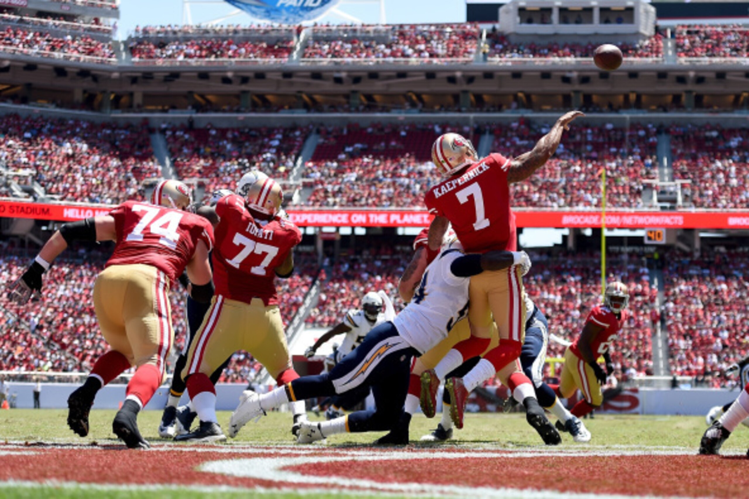 SANTA CLARA, CA - AUGUST 24: Quarterback Colin Kaepernick #7 of the San Francisco 49ers gets hit as he throws by one of the San Diego Chargers at Levi's Stadium on August 24, 2014 in Santa Clara, California. (Photo by Thearon W. Henderson/Getty Images)