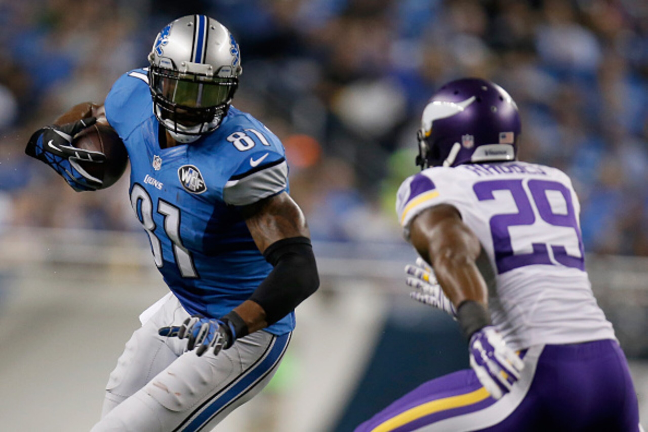 DETROIT, MI - DECEMBER 14: Calvin Johnson #81 of the Detroit Lions tries to avoid the tackle by Xavier Rhodes #29 of the Minnesota Vikings in the third quarter at Ford Field on December 14, 2014 in Detroit, Michigan. (Photo by Gregory Shamus/Getty Images)