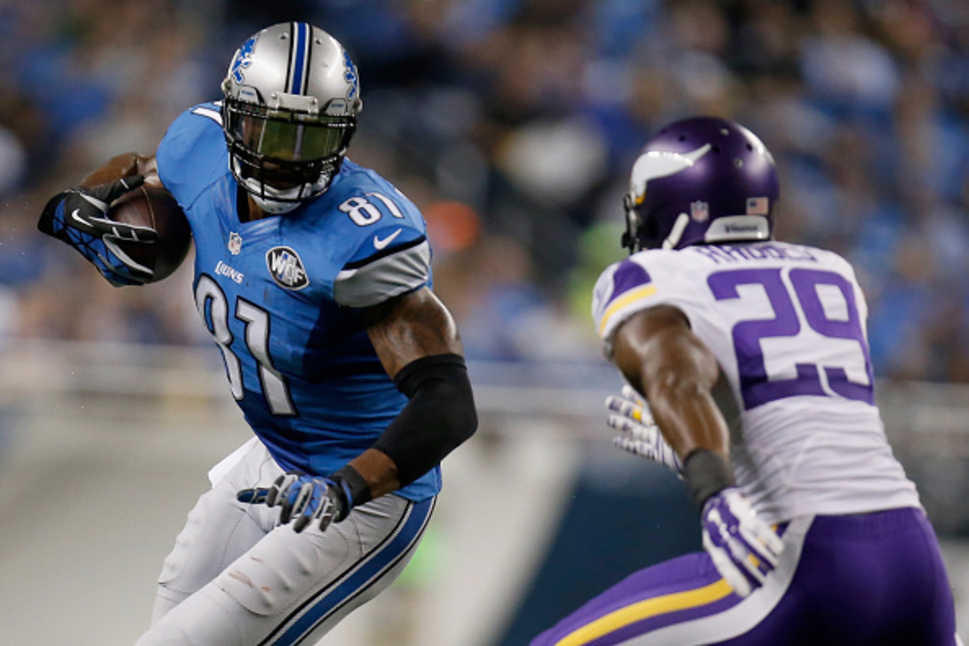 DETROIT, MI - DECEMBER 14: Calvin Johnson #81 of the Detroit Lions tries to avoid the tackle by Xavier Rhodes #29 of the Minnesota Vikings in the third quarter at Ford Field on December 14, 2014 in Detroit, Michigan. (Photo by Gregory Shamus/Getty Images)