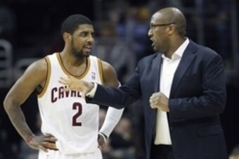 Feb 25, 2014; Cleveland, OH, USA; Cleveland Cavaliers head coach Mike Brown talks with point guard Kyrie Irving (2) against the Toronto Raptors during the fourth quarter at Quicken Loans Arena. The Raptors won 99-93. Mandatory Credit: Ron Schwane-USA TODA