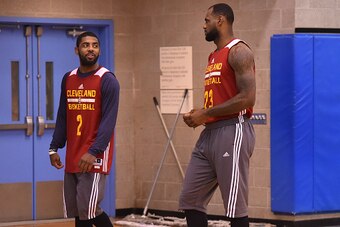 NEW YORK, NY- DECEMBER 7:  LeBron James #23 and Kyrie Irving #2 of the Cleveland Cavaliers smile and talk at practice on December 7, 2014 at Baruch College in New York, New York. NOTE TO USER: User expressly acknowledges and agrees that, by downloading an