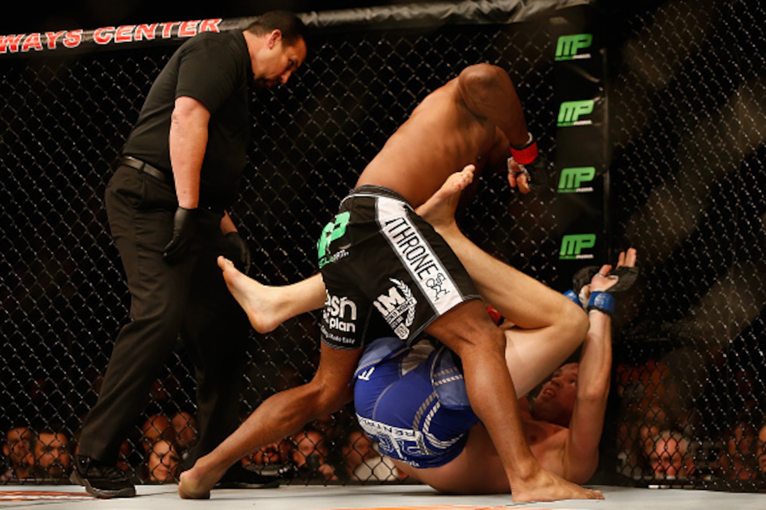 PHOENIX, AZ - DECEMBER 13:  Alistair Overeem punches Stefan Struve as he lays against the cage in their heavyweight bout during the UFC Fight Night event at the at U.S. Airways Center on December 13, 2014 in Phoenix, Arizona.  (Photo by Christian Petersen