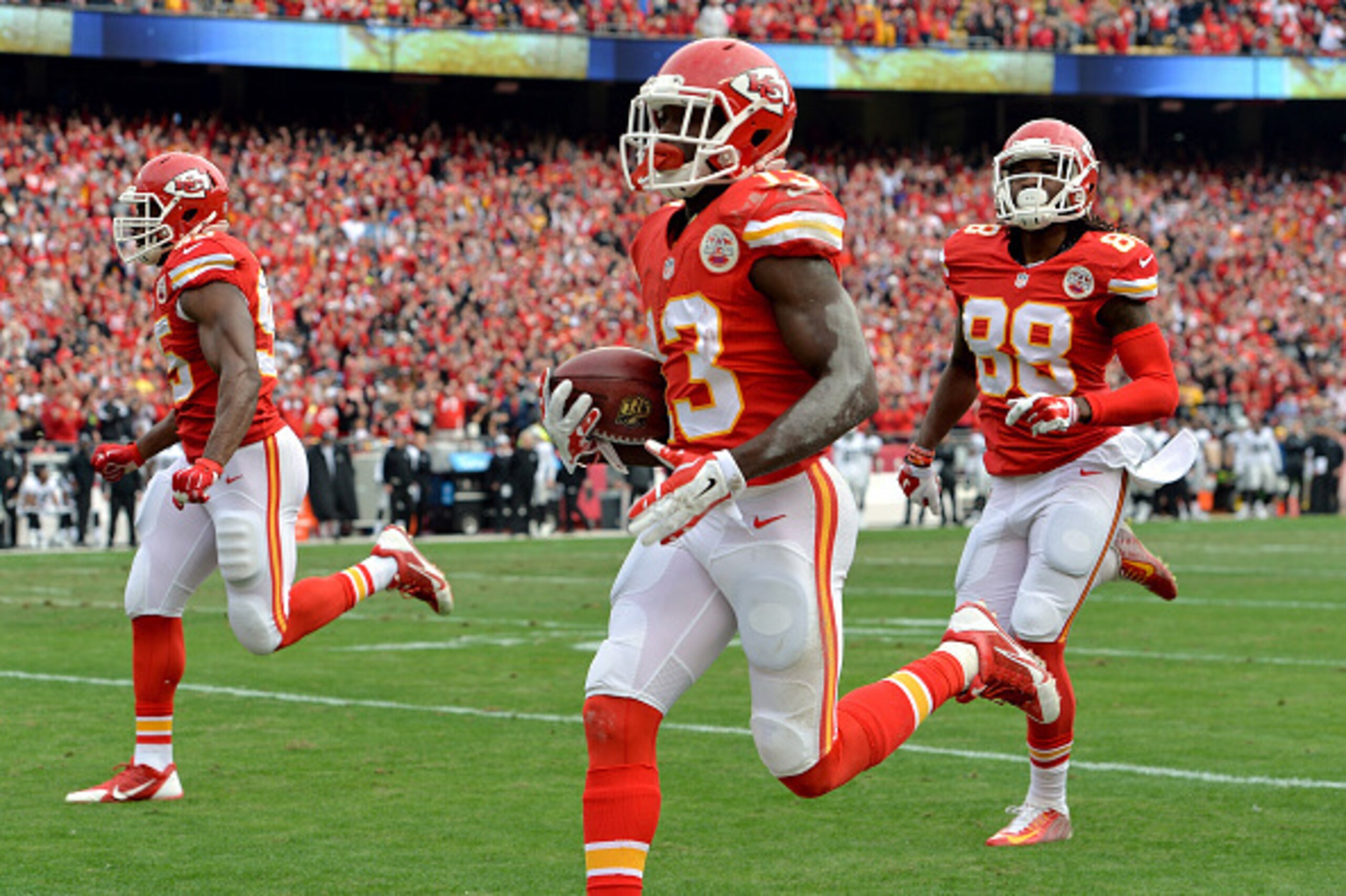 KANSAS CITY, MO - DECEMBER 14:  De'Anthony Thomas #13 of the Kansas City Chiefs returns a punt for a touchdown against the Oakland Raiders during the first quarter at Arrowhead Stadium on December 14, 2014 in Kansas City, Missouri.  (Photo by Peter Aiken/
