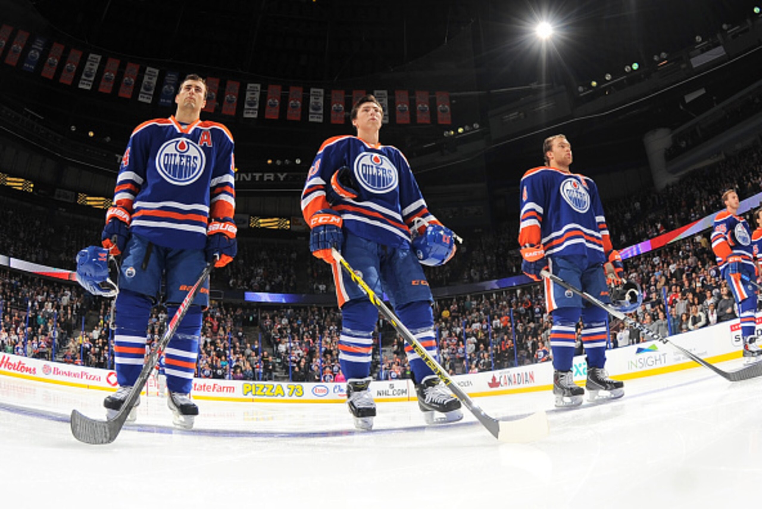 EDMONTON, AB - OCTOBER 20: Taylor Hall #4, Ryan Nugent-Hopkins #93, Jordan Eberle #14 of the Edmonton Oilers stand for the singing of the national anthem prior to a game against the Tampa Bay Lightning on October 20, 2014 at Rexall Place in Edmonton, Albe