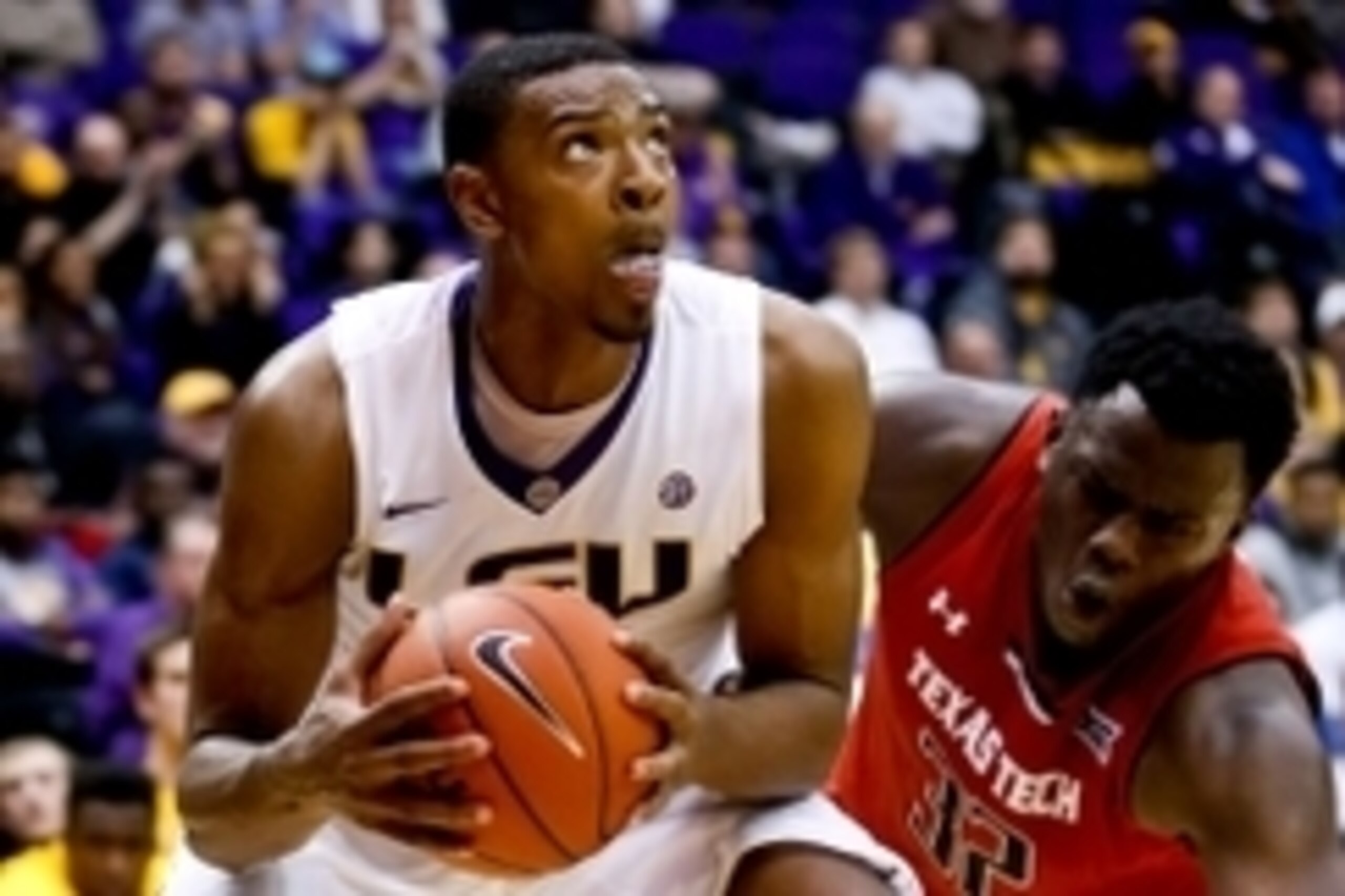 Nov 18, 2014; Baton Rouge, LA, USA; LSU Tigers forward Jordan Mickey (25) drives past Texas Tech Red Raiders forward Norense Odiase (32) during the second half of a game at the Pete Maravich Assembly Center. LSU defeated Texas Tech 69-64 in overtime. Mand
